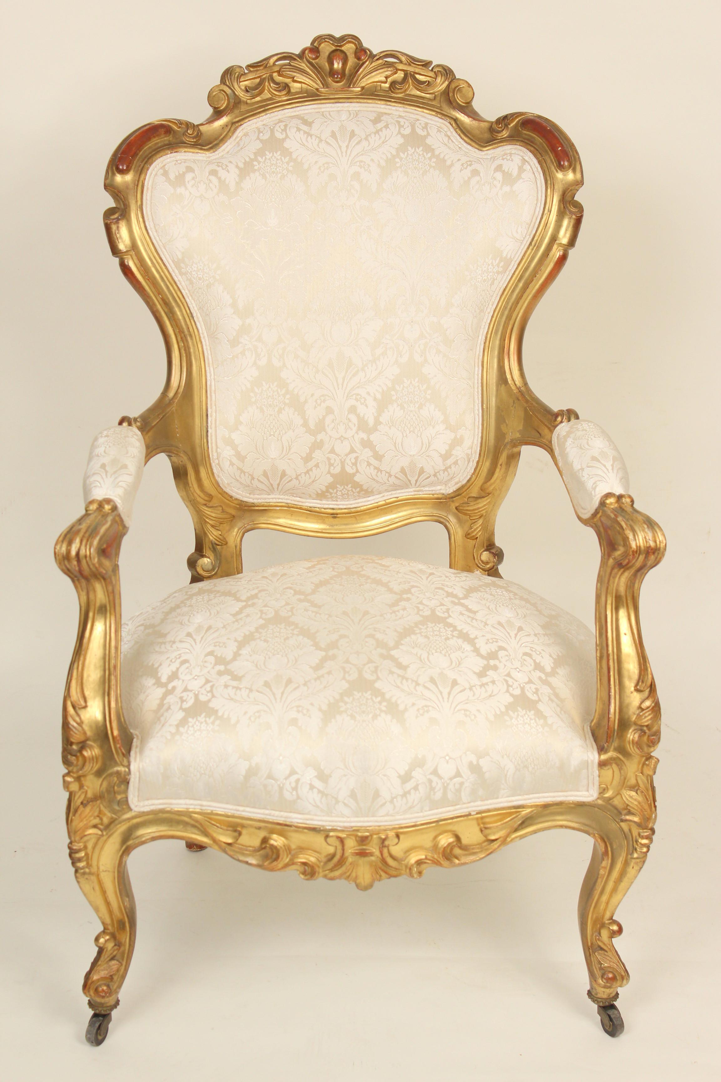 European Pair of continental Napoleon III gilt wood armchairs