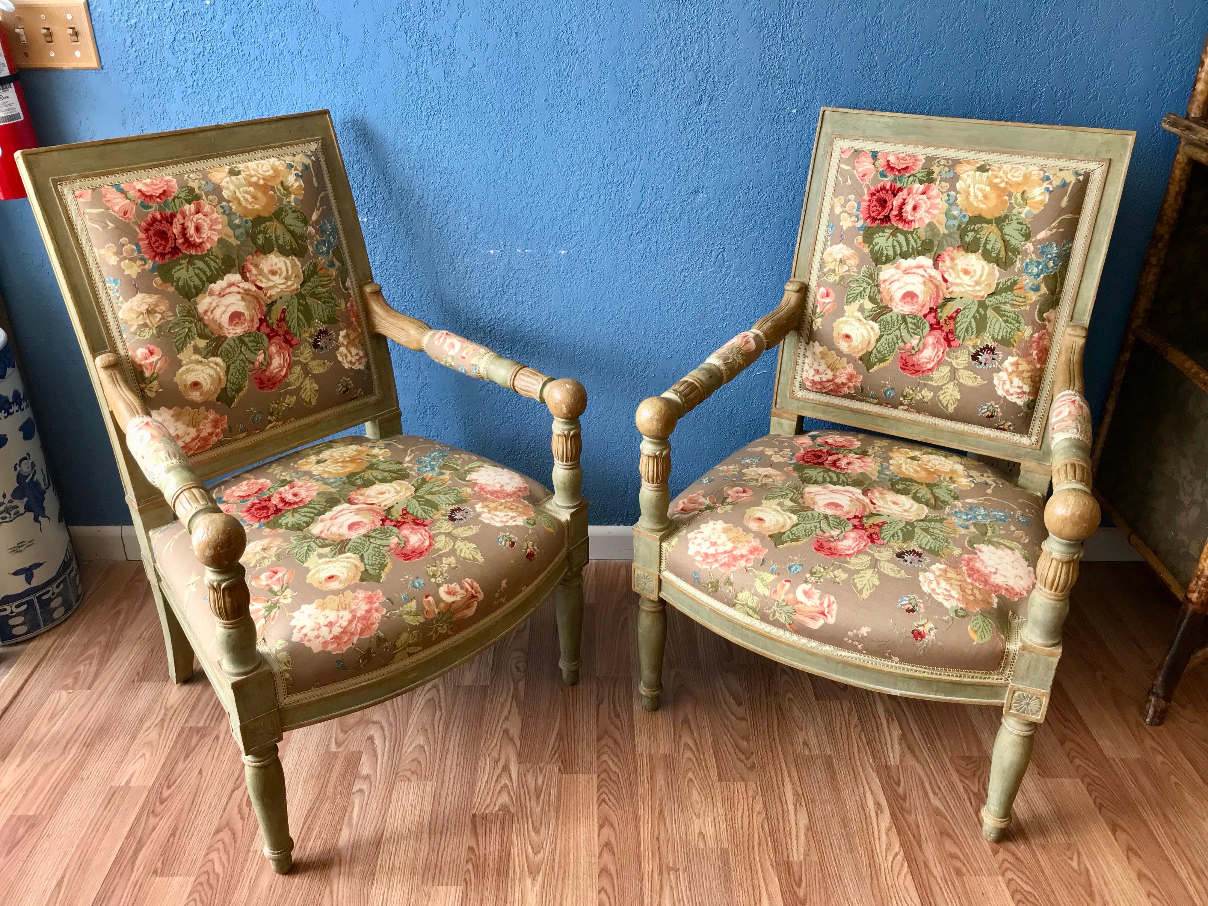 The carved chairs are finished with a tasteful green wash and upholstered with a lovely floral fabric.