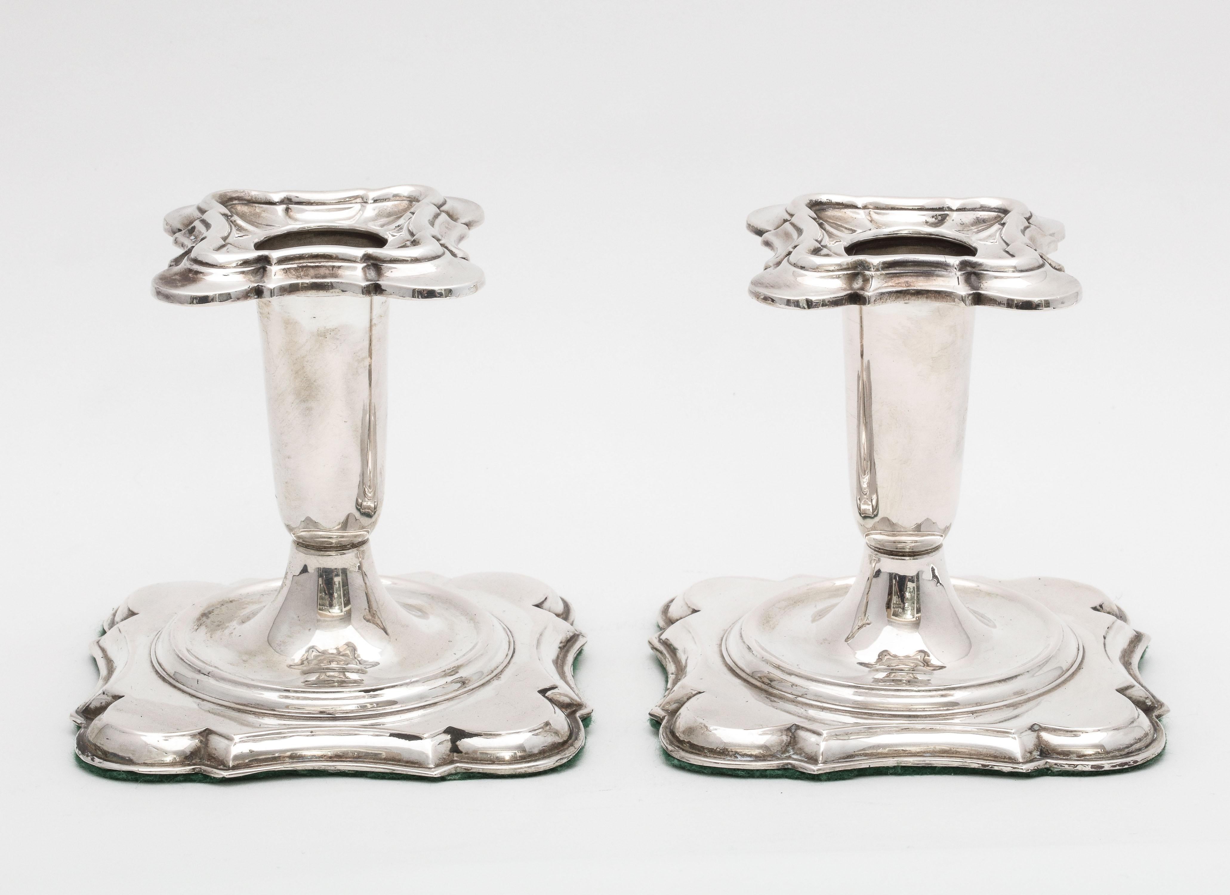 Georgian- style pair of continental silver (.835) candlesticks, Norway, circa 1930s, Theodor Olsens, maker. Each of the candlesticks measures 3 3/4 inches high x 3 3/4 inches wide x 3 3/4 inches deep. Base of each candlestick is weighted and is