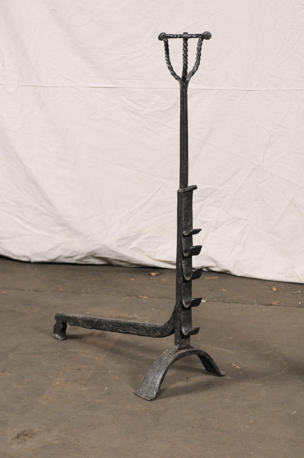 Pair of continental tall black primitive andirons with port warmers, circa 1900.