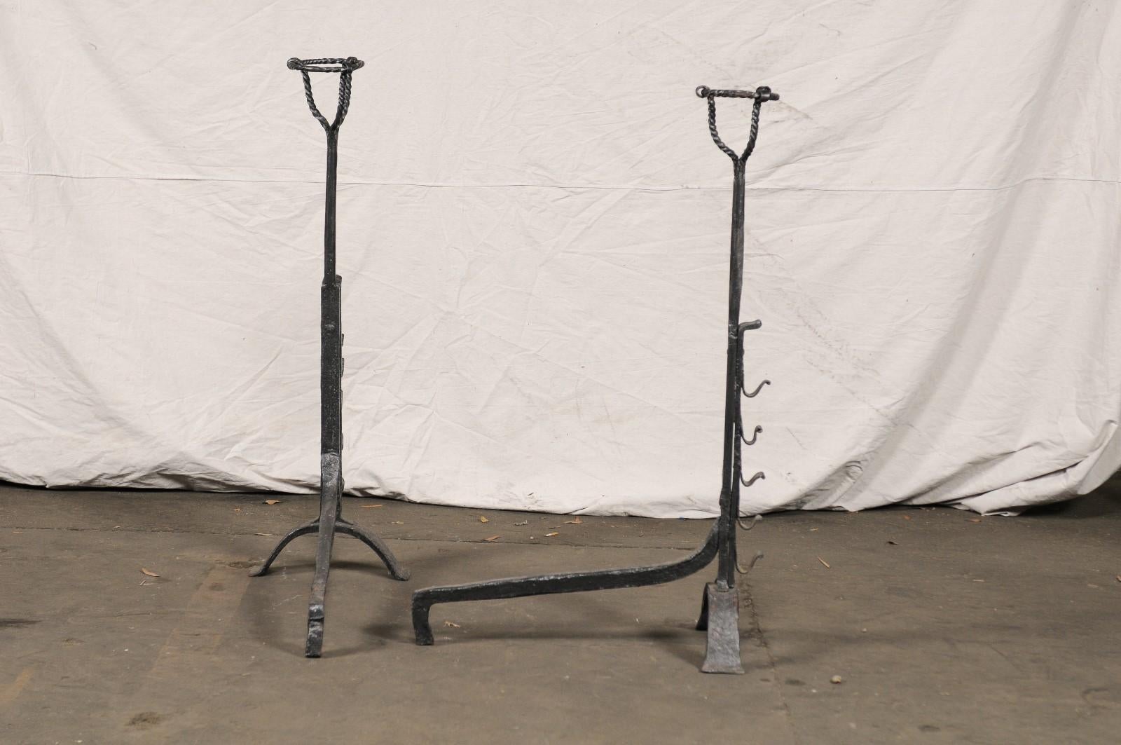 Iron Pair of Continental Tall Black Primitive Andirons with Port Warmers, circa 1900 For Sale