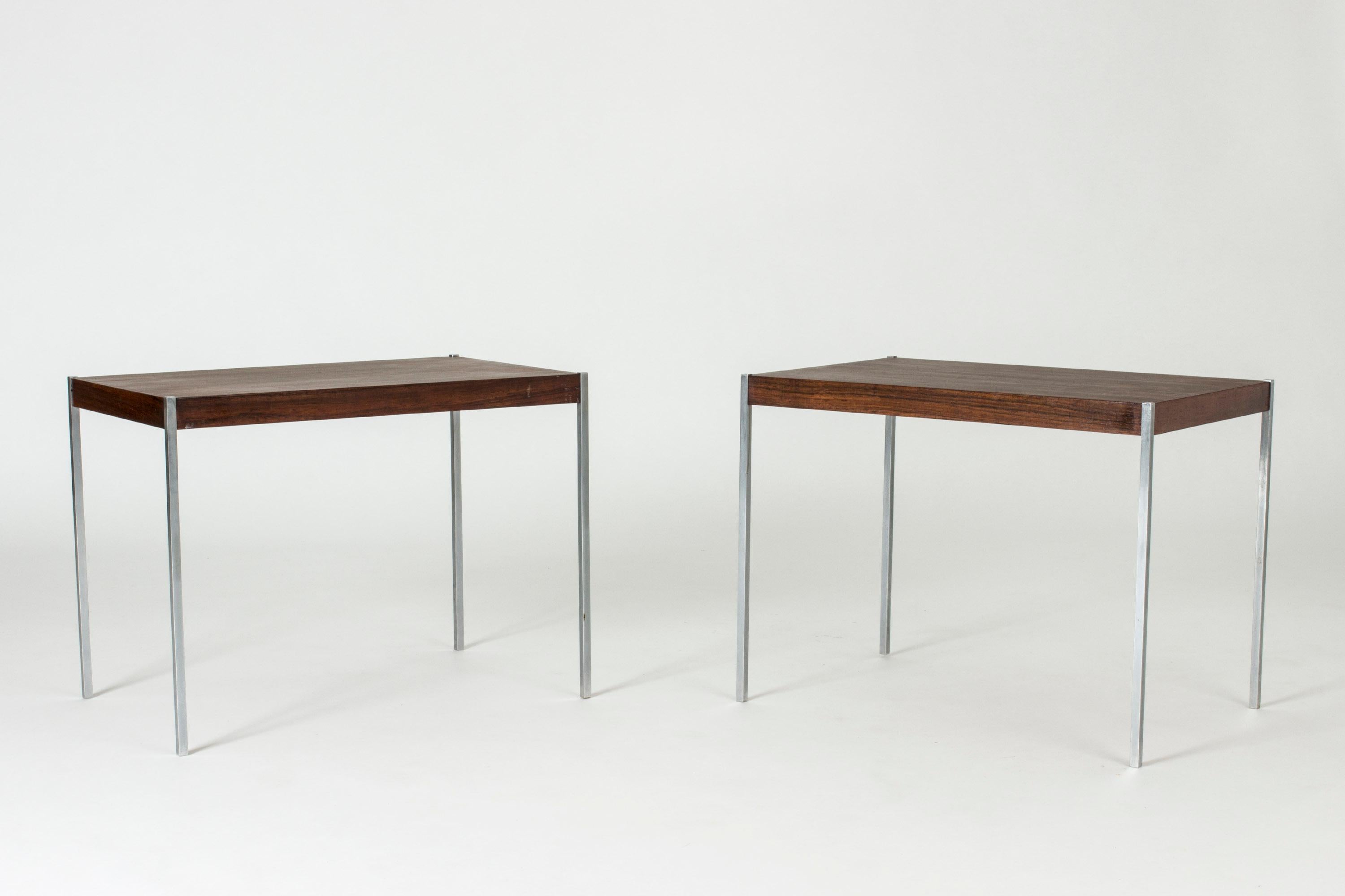 Pair of cool side tables by Uno and Östen Kristiansson. Sleek, square steel legs fitted neatly into the rosewood table tops.