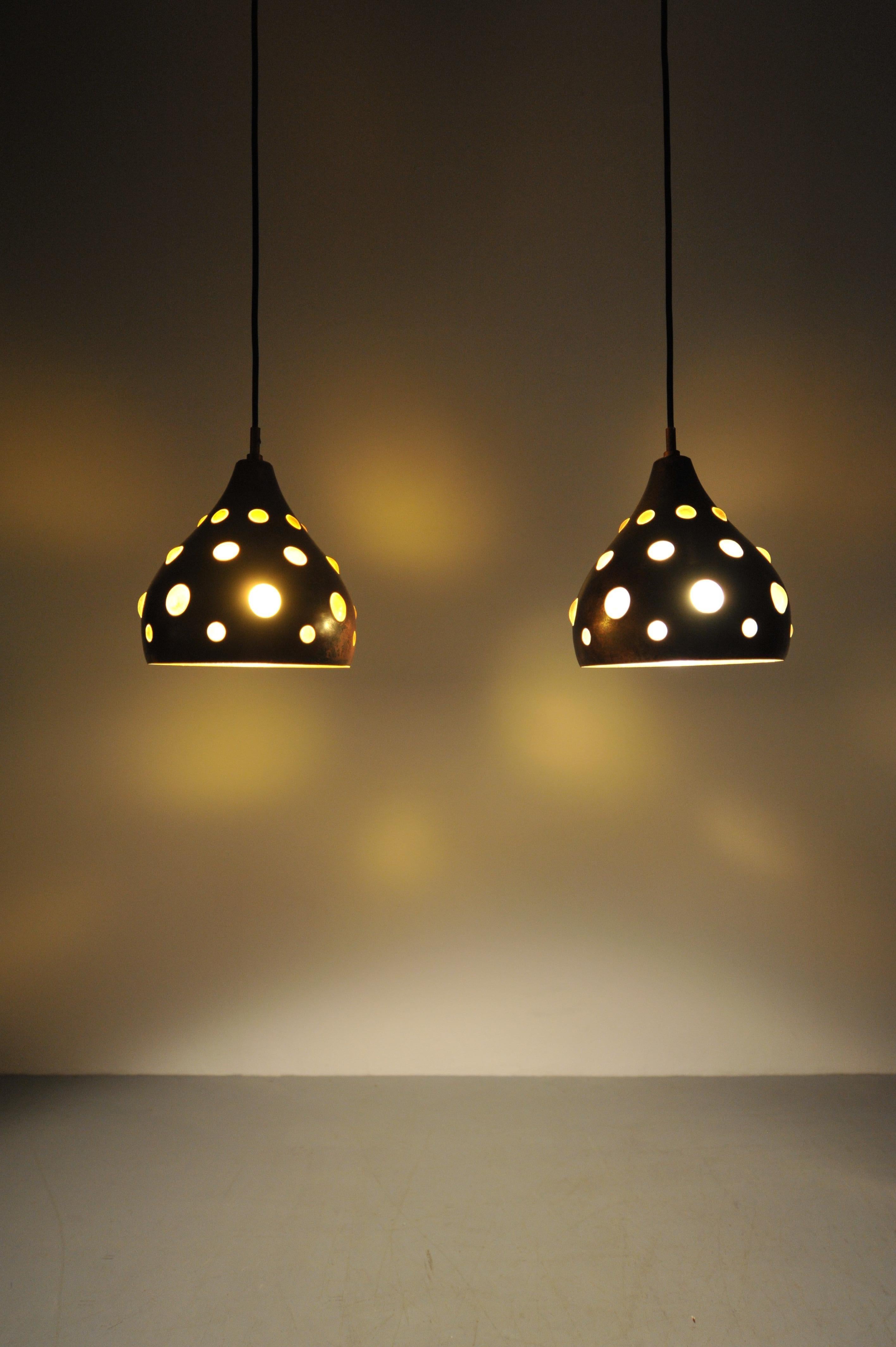 Pair of decorative copper ceiling lights from the 1960s, featuring hand-blown colored glass inserts. Often attributed to Nanny Still, though not by her hand, these pieces embody the playful yet refined material mix typical of mid-century European