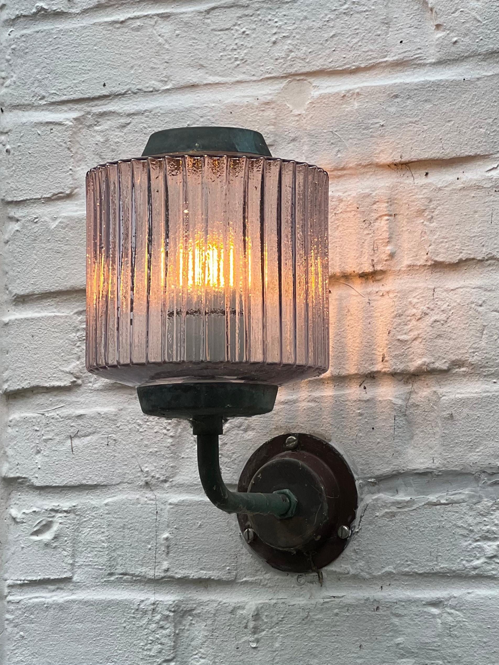 This is a pair of copper and textured glass wall lamps in the taste of Swedish architect and designer Hans Bergström. It can be used outside as it was used for 70 years but you can use it inside. There is elegant details. The textured glass provide