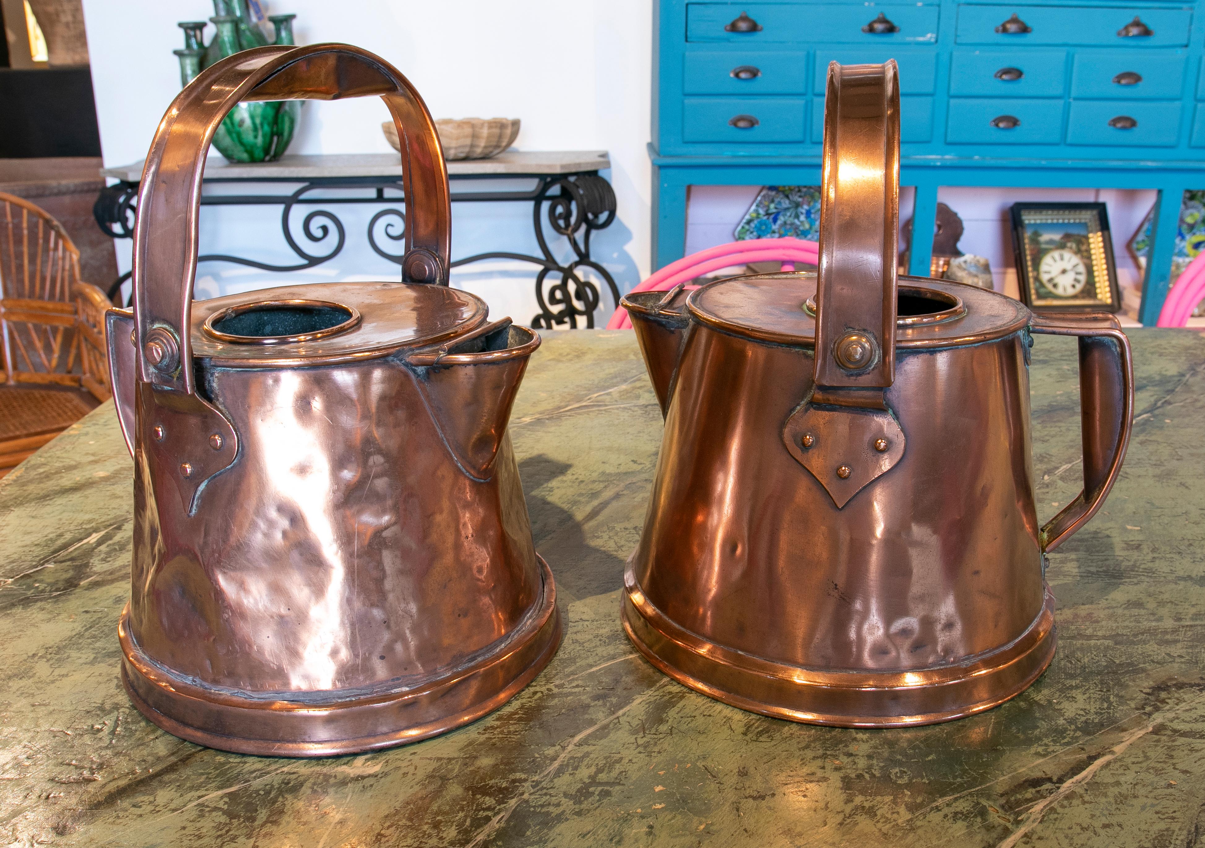 Pair of copper milk jars from the XIX century with a handle at the top.
