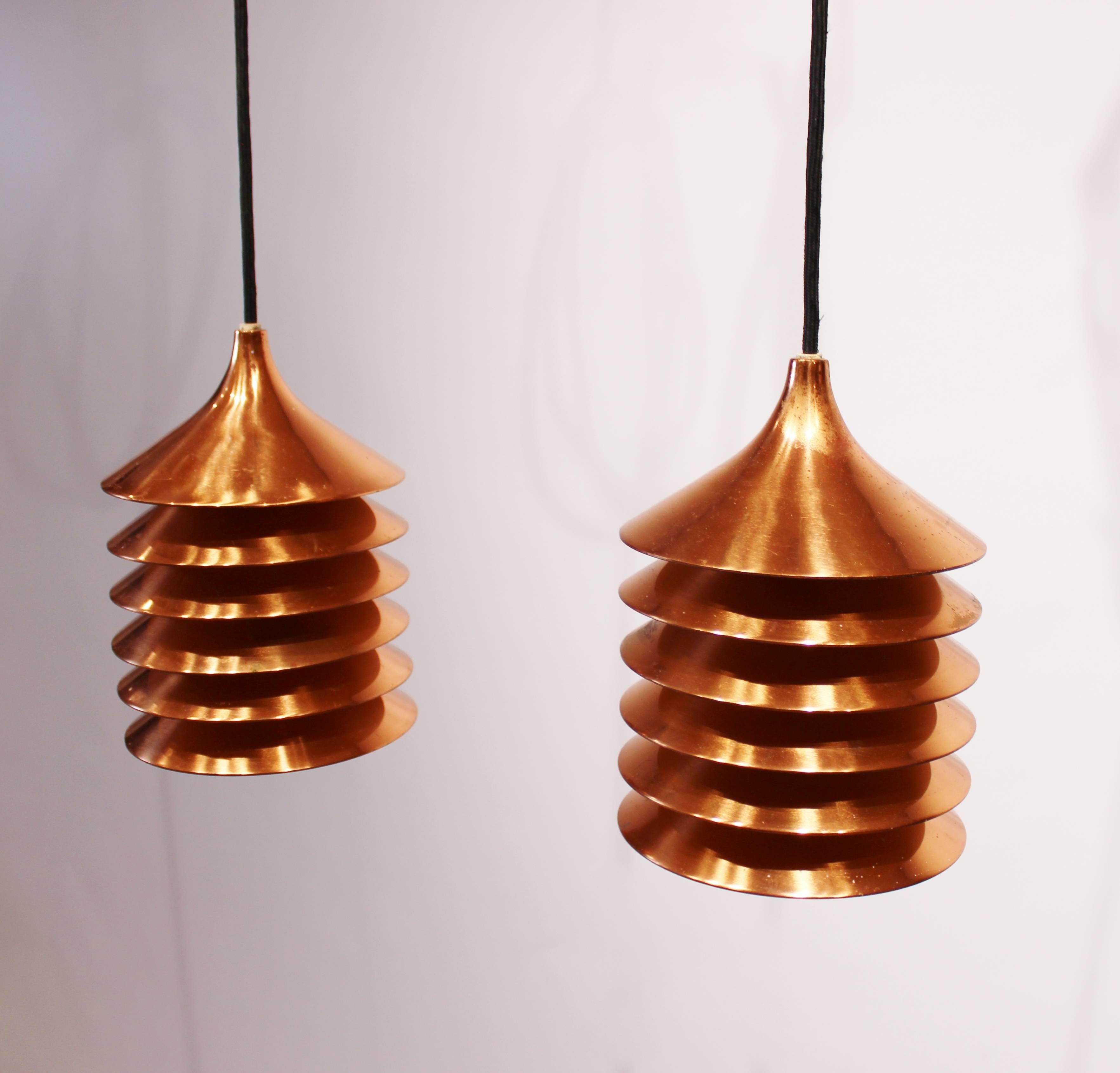 A pair of copper pendants of Danish design from the 1960s. The pendants are in great vintage condition with new black fabric cord.