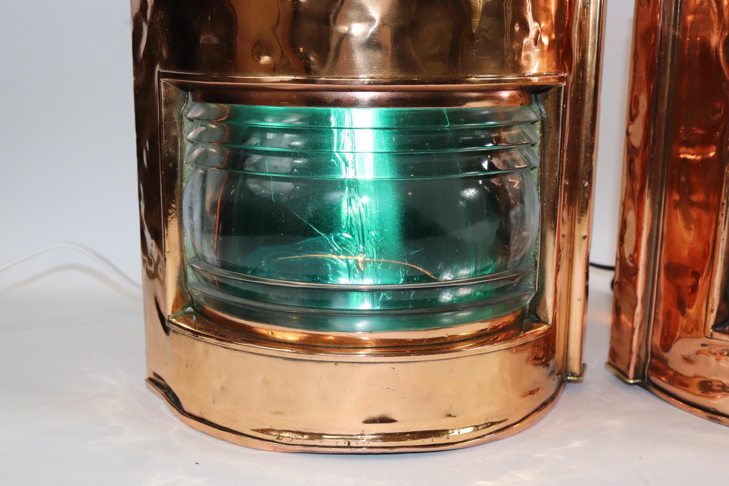 Pair of highly polished and lacquered copper port and starboard ship lanterns with brass makers badges from Telford Grier and Mackay. Dated 1916 on rear door. Clear glass fresnel lenses with removable red and green filters. The green filter is