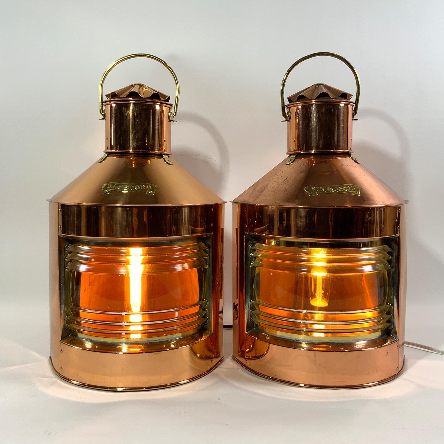 Highly polished ships lanterns with Fresnel glass lenses. Vented tops with fluted chimney and brass carry handles. Fitted with brass 
