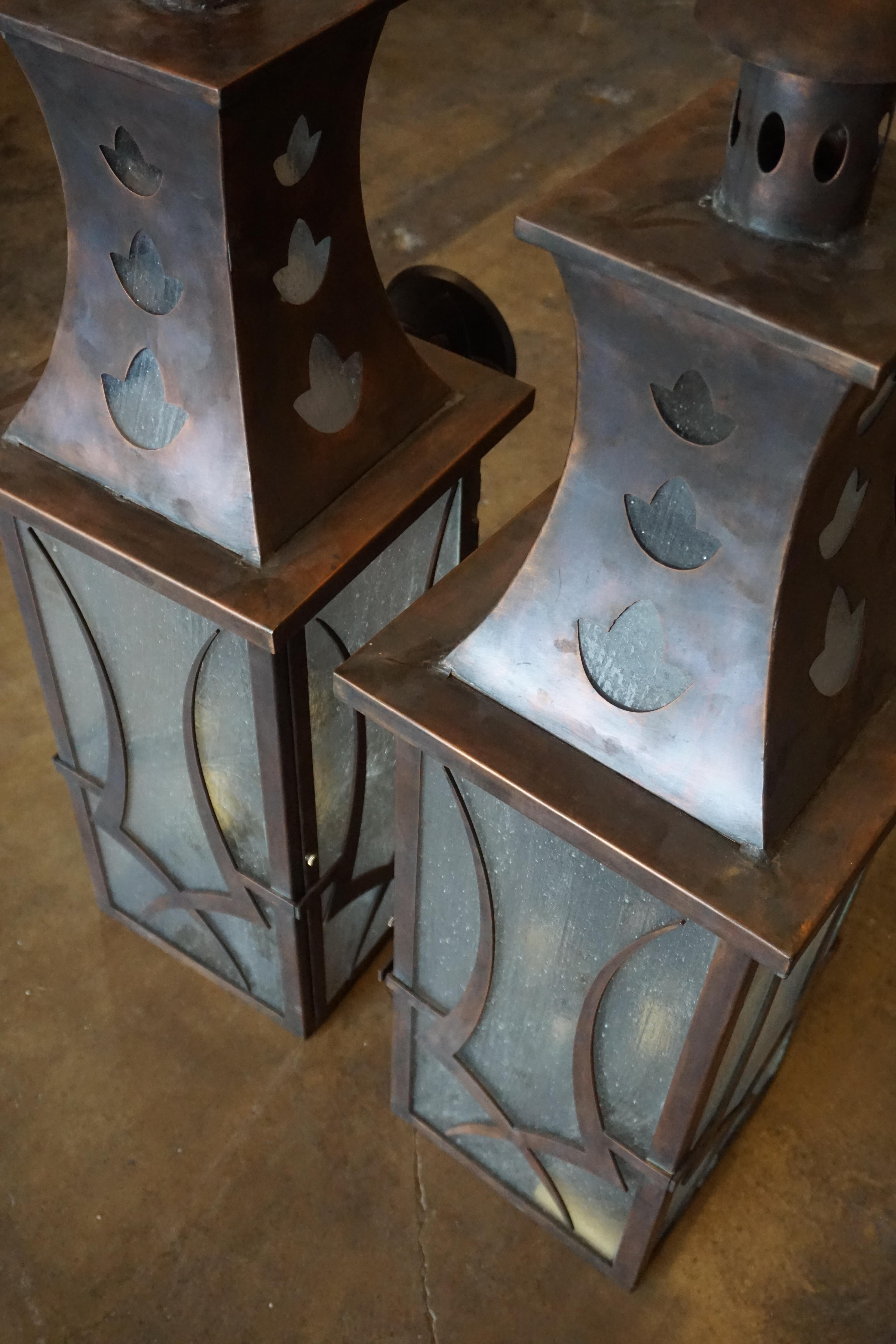 This pair of copper lanterns are made of copper and crafted in the United States. 

Measurements: 11.5'' W x 16.5'' D x 36'' H