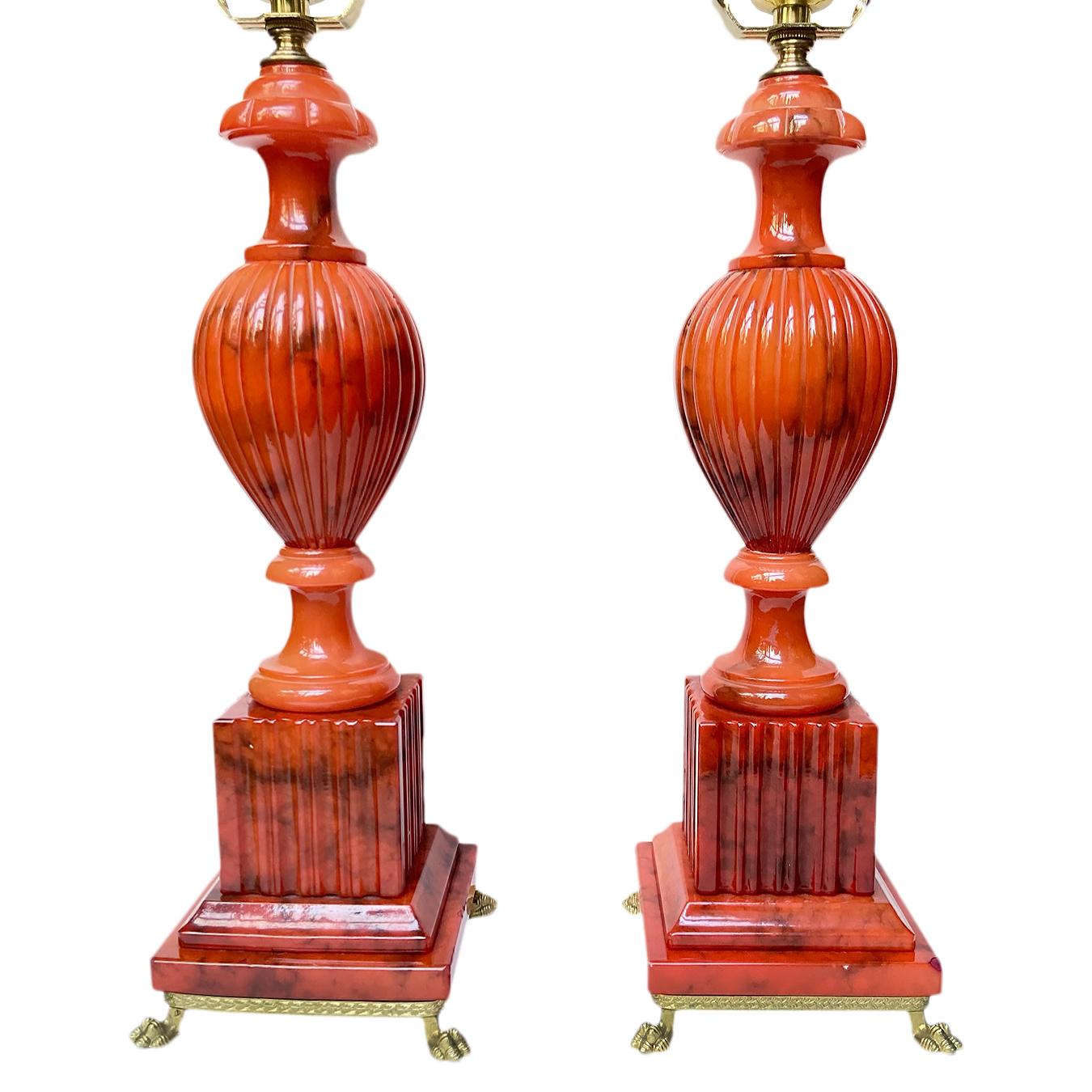 Pair of circa 1940's Italian coral-colored carved alabaster lamps with footed bronze bases.

Measurements:
Height of body 14.5