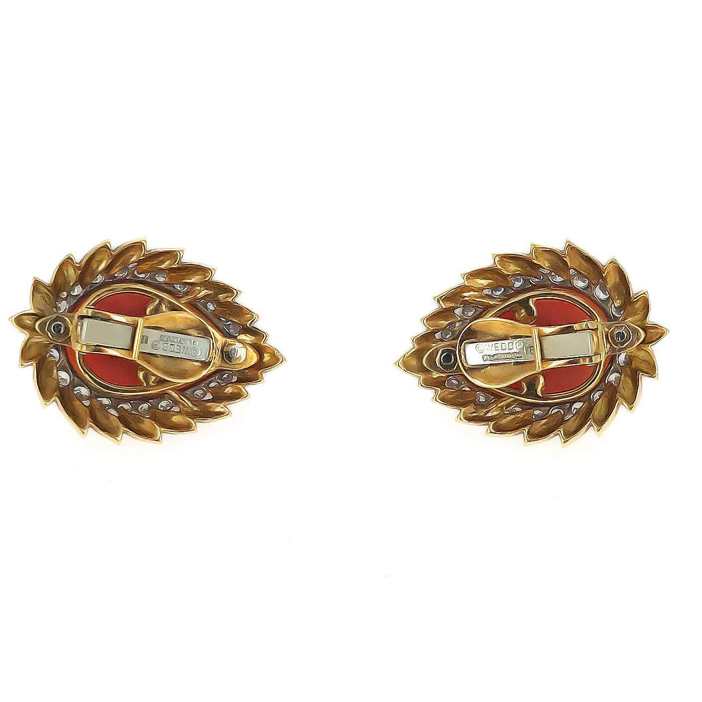 This beautiful pair of David Webb clip earrings is composed of carved fluted pear shaped coral surrounded by a halo of brilliant cut diamonds and set in 18 karat hammered yellow gold. Each measures approximately 3.3 x 2.5 cm.