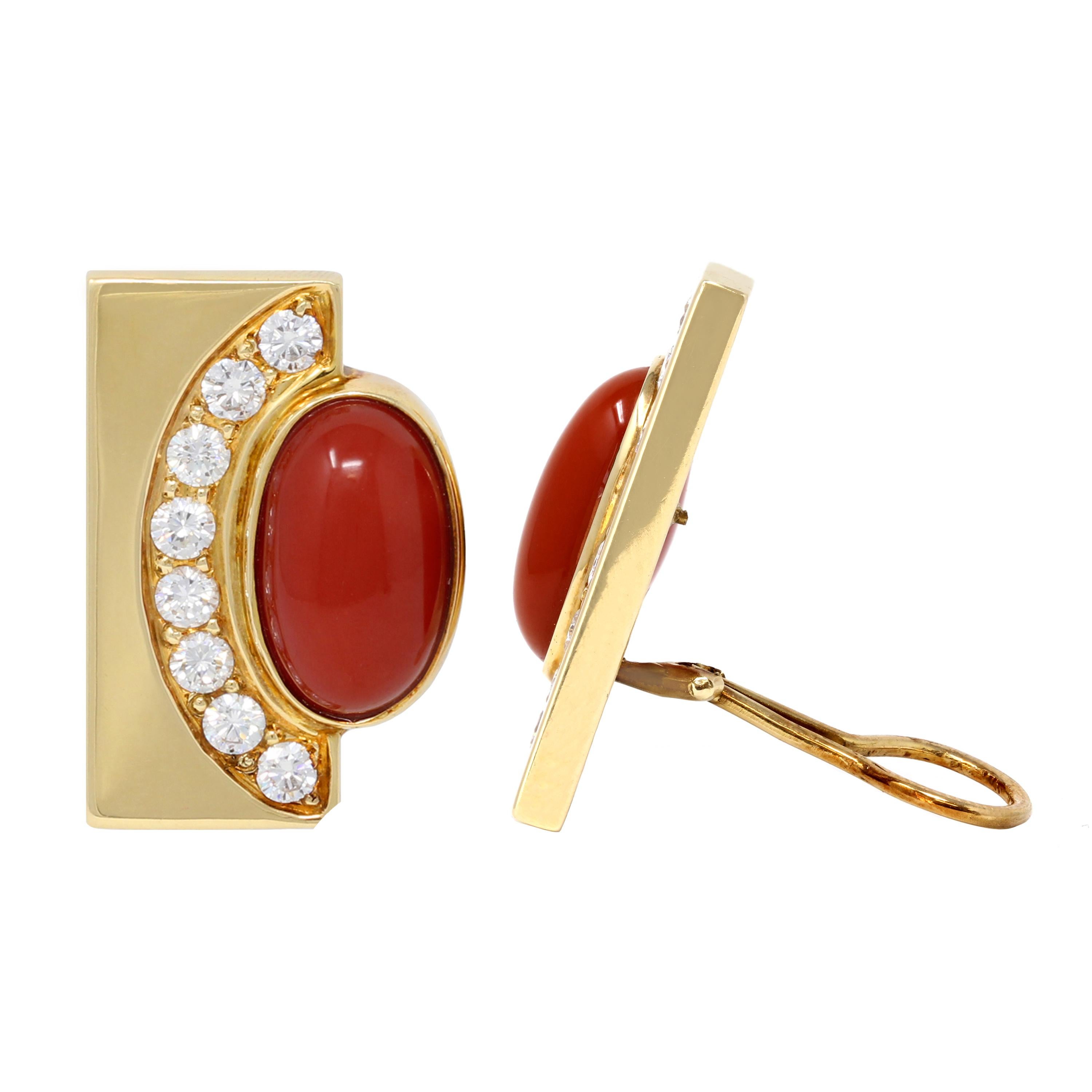 Of geometric styling set with two cabochon corals, half framed by round diamonds weighing approximately 3.00 carats, within polished gold half frames, gross weight 23.7 grams, measuring 1¼ by ⅞ inches.