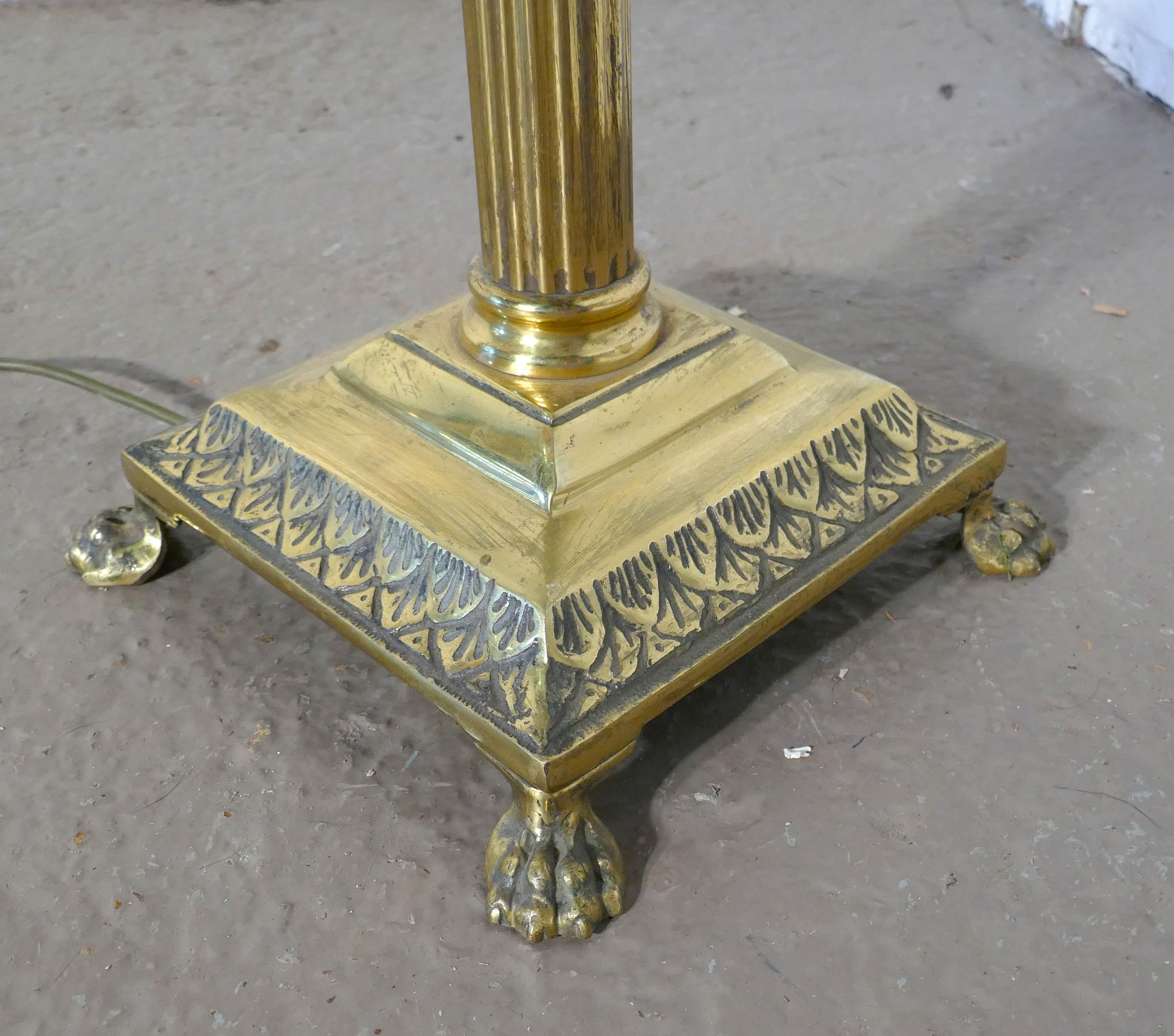 Pair of Corinthian column floor lamps brass standard lamps 

These are a great pair of very decorative floor lamps, the bases are square and they have Lions Paw feet, one on each corner, the lamps have a central Corinthian column also in