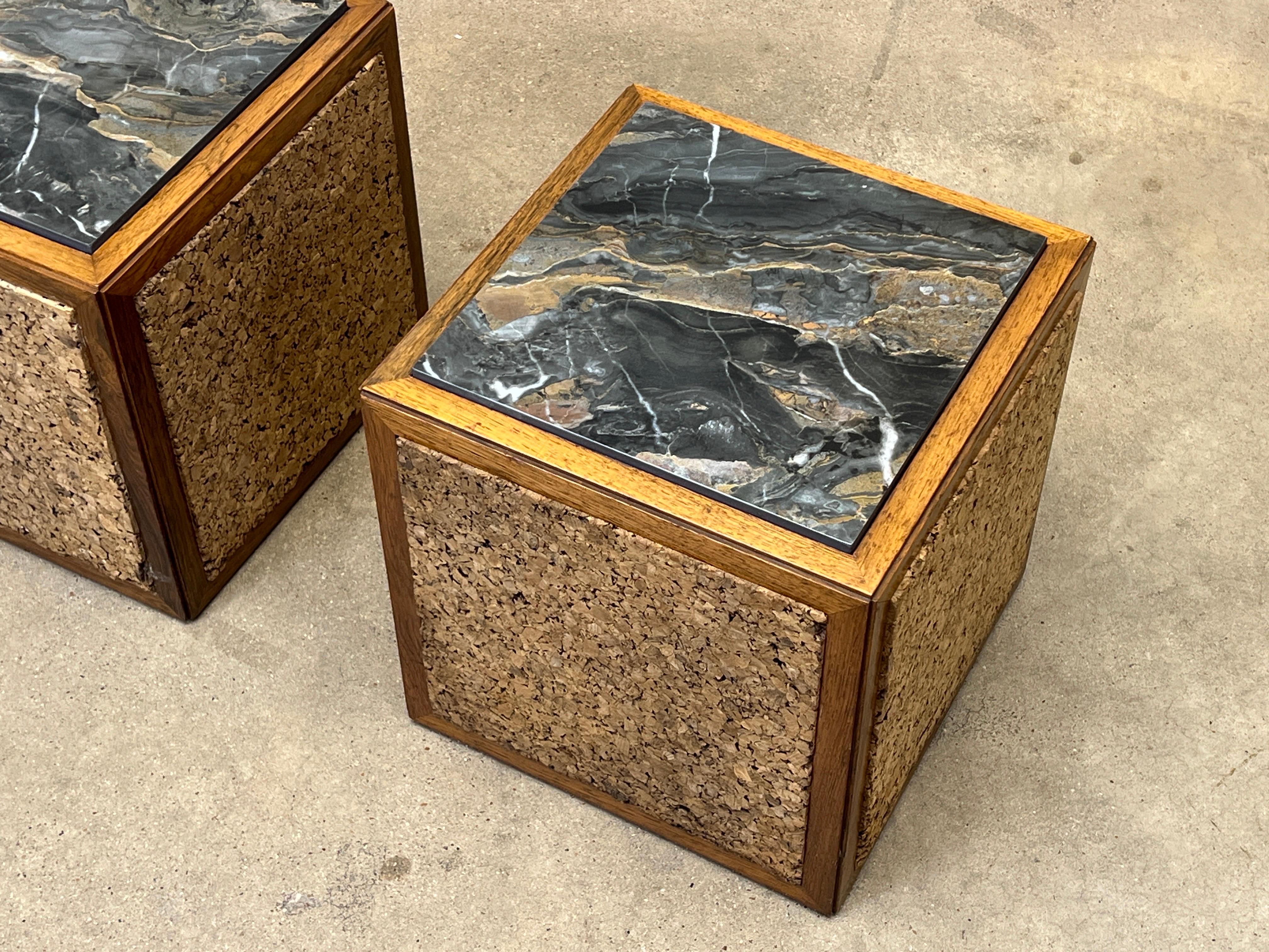 A pair of cube tables with cork sides and a marble top. Designed by Edward Wormley for Dunbar. 