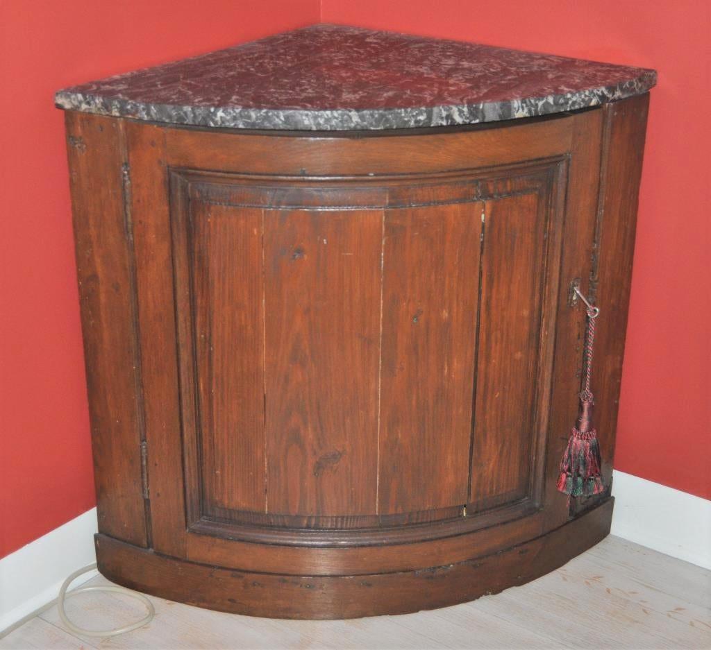 A pair of pine and walnut corner cabinets, each with a single curved door and an original grey marble top, circa 1760, French.
