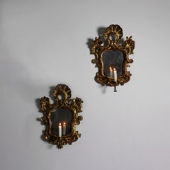 Pair of cornucopias with carved and gilded frames, original silvered glass panes