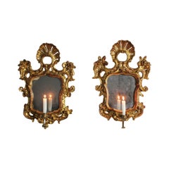 Pair of cornucopias with carved and gilded frames, original silvered glass panes
