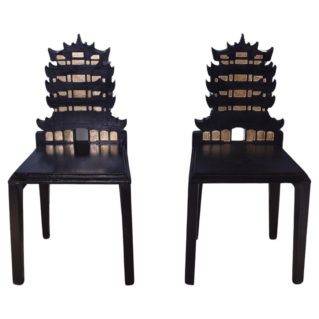 An ornate pair of Chinese Pagoda chairs by the Italian designer Cosimo De Vita.

The chairs are hand crafted in Florence from solid Fir wood and finished in a black paint with gold leaf detail, both chairs are signed and dated by Cosimo De
