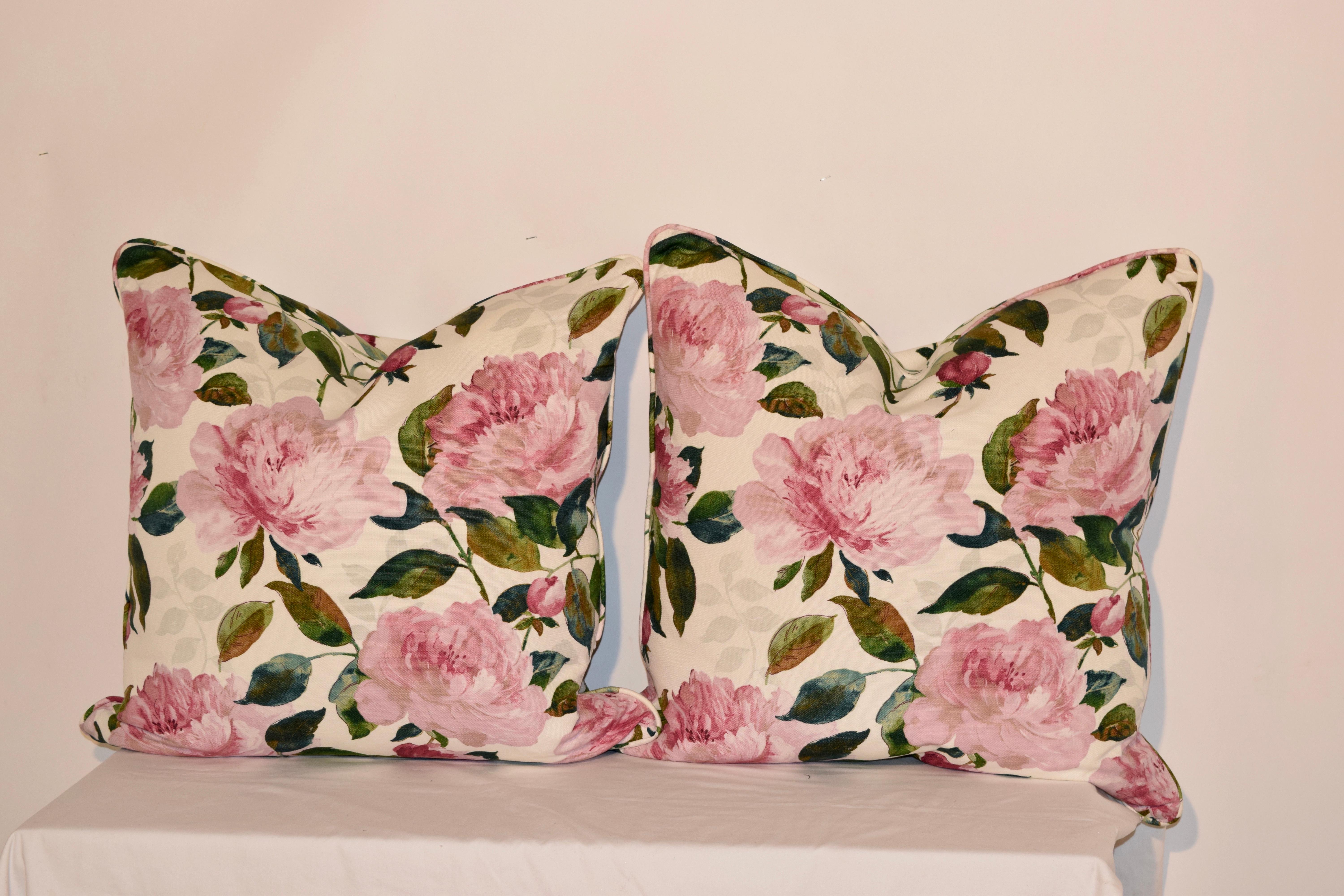 Handmade pillows from Bolsters. The pillows are made from printed cotton fabric and are embellished with matching welt made from the same fabric. The pillow covers have hidden zippers and the inserts are removable and are made from feathers.