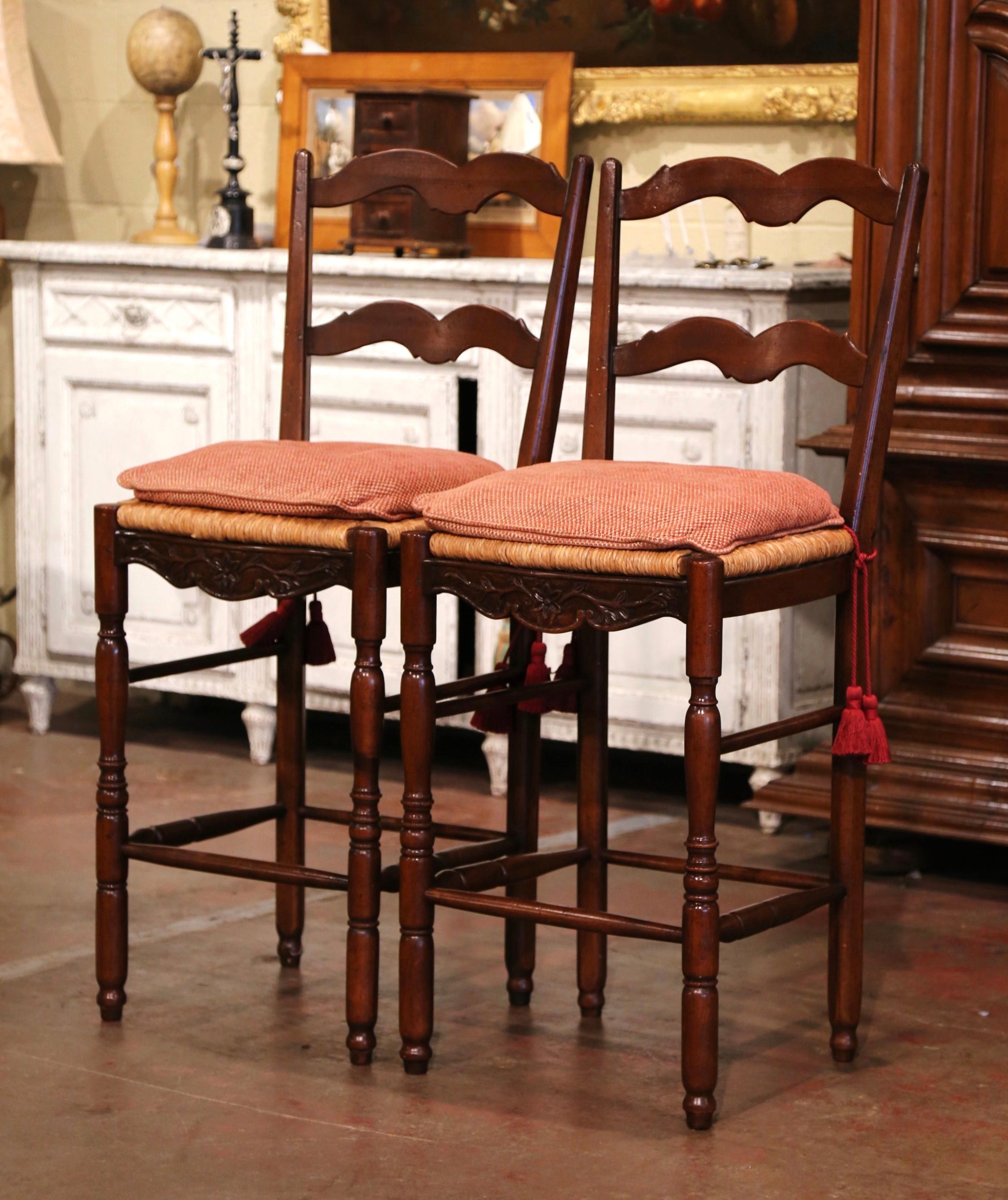 Place these stools around a kitchen bar counter for extra seating. Crafted in Normandy, France circa 2000, the Classic stools are 27” in seat height, the perfect height for a tall bar! Each two ladder back chair stands on turned legs with foot