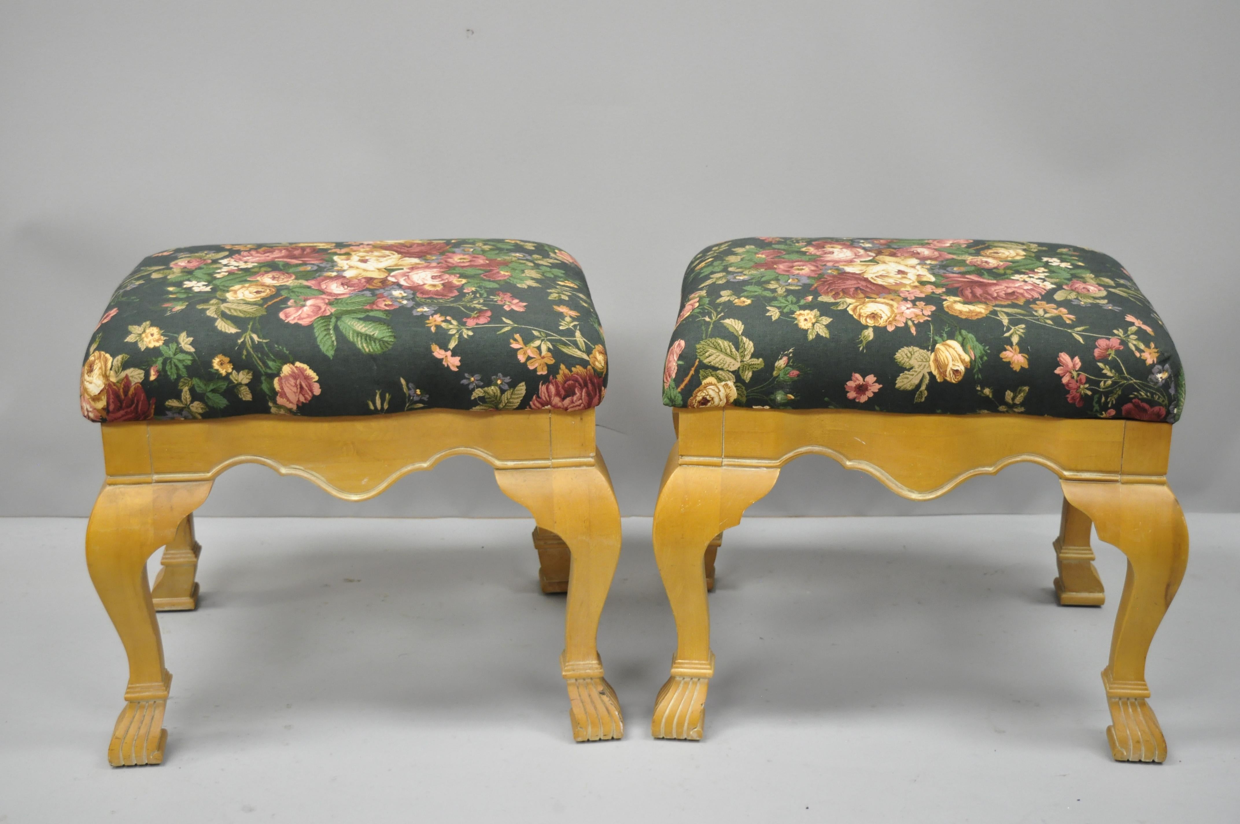 Pair of Country French style cabriole leg hoof foot upholstered stools. Items feature solid wood construction, beautiful wood grain, floral upholstered seats, distressed finish, cabriole legs, great style and form, circa late 20th century.