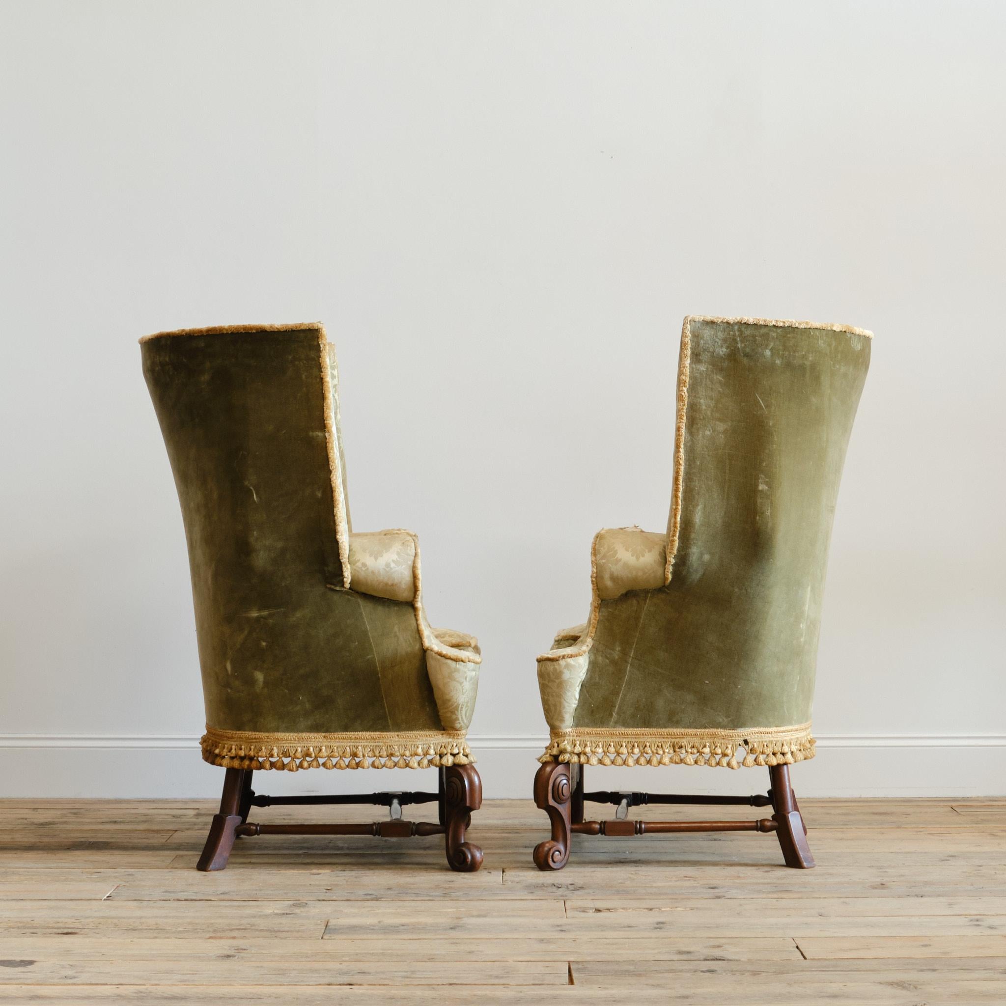 A pair of c1900 barrel back armchair of large country house proportions. Raised on carved legs joined by turned stretchers and a and a thick decorative front stretcher. 

A good shapely model and in good solid condition with tight original