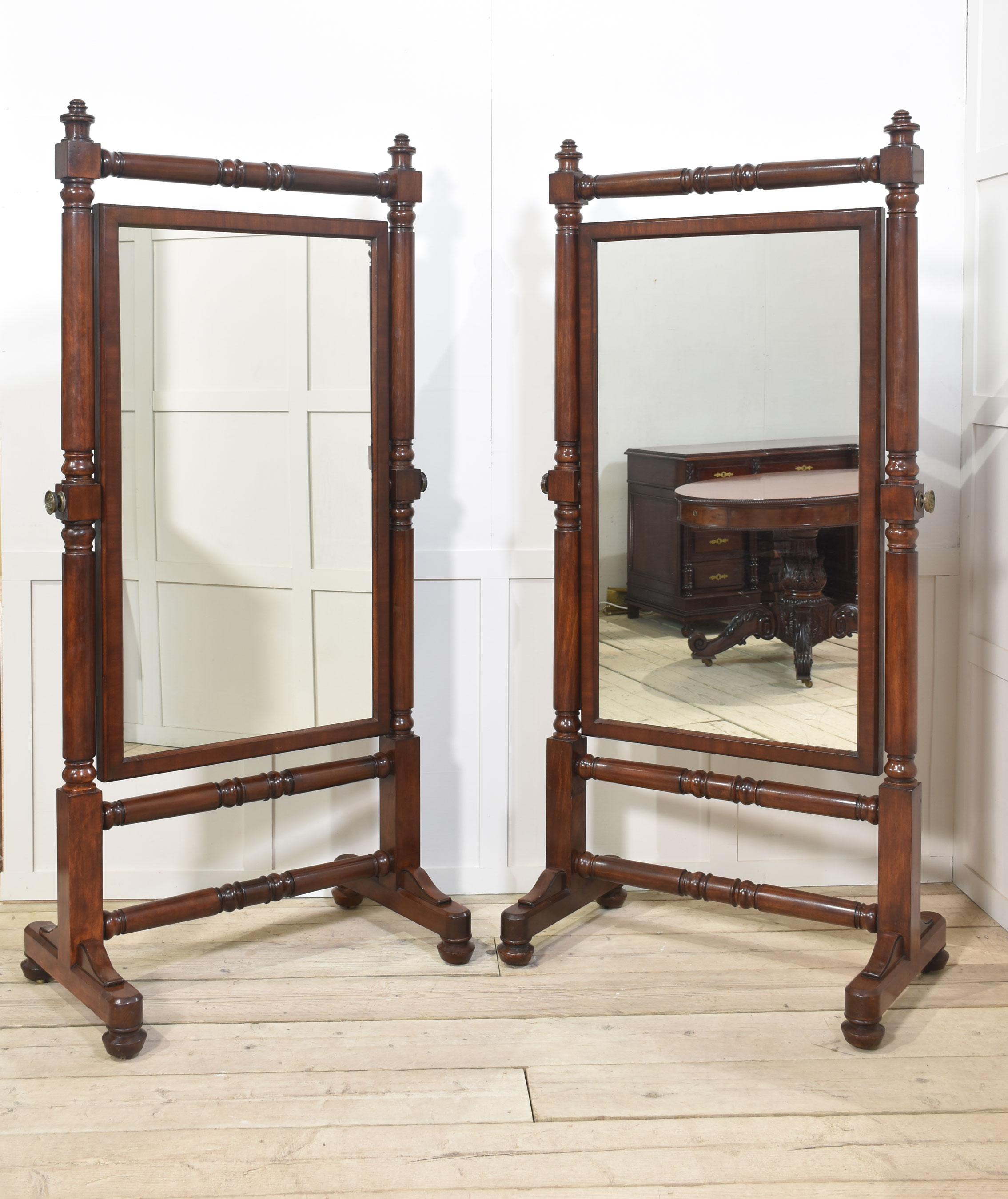 Pair of large mahogany cheval mirrors. The original mirror plate within a moulded frame, between turned column, supports on a raised platform ends, terminating in bun feet.
Dimensions
Height 74 Inches
Width 36.5 Inches
Depth 22 Inch