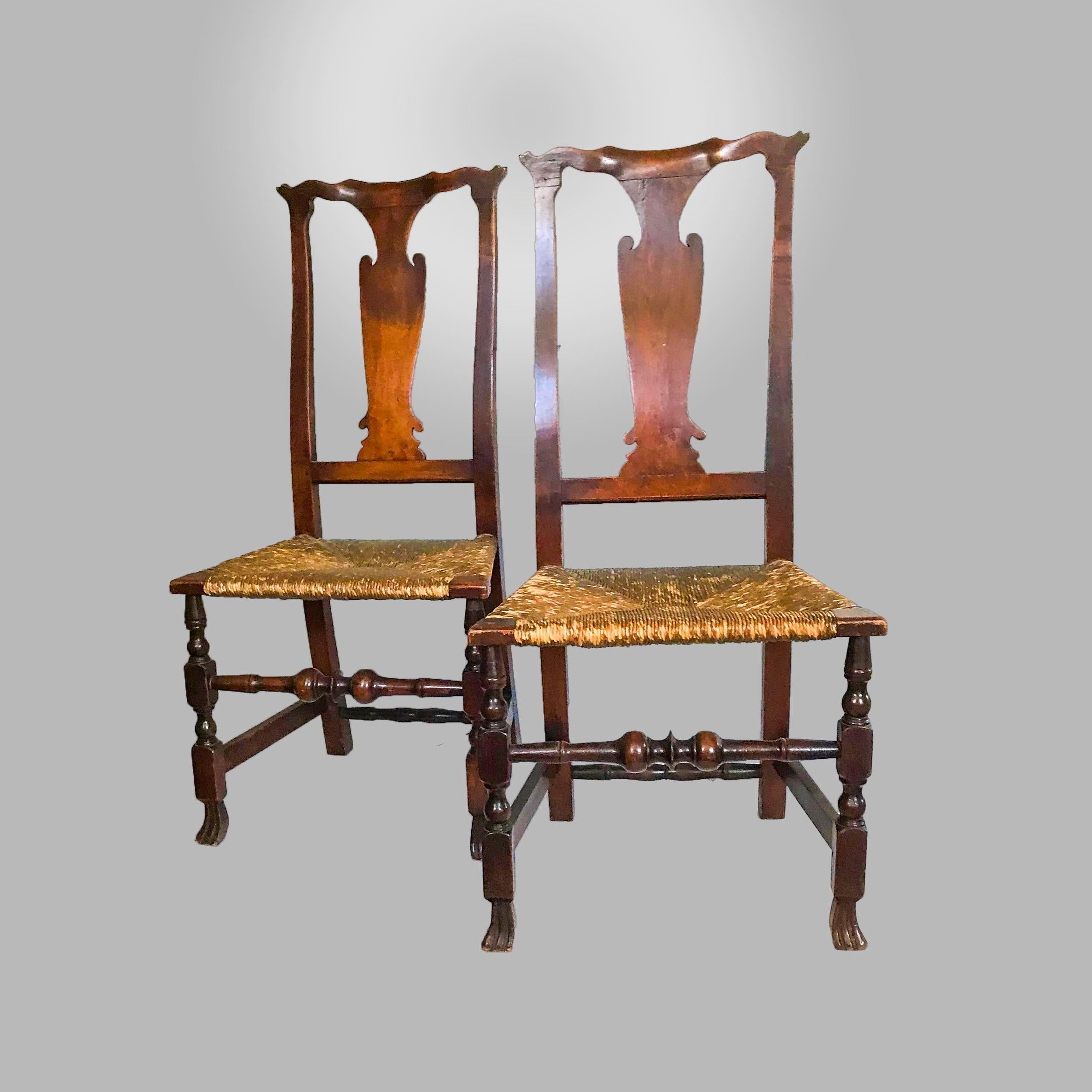 Made of walnut each with chamfered yoke crest with raked ears, shaped vase splat and rush seat, block and turned legs with boldly turned front stretcher ending in Spanish feet
Southern Massachusetts, possible Nantucket, circa 1740-1760.
 