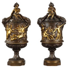 Antique Pair of covered vases in chased bronze with a rich decoration