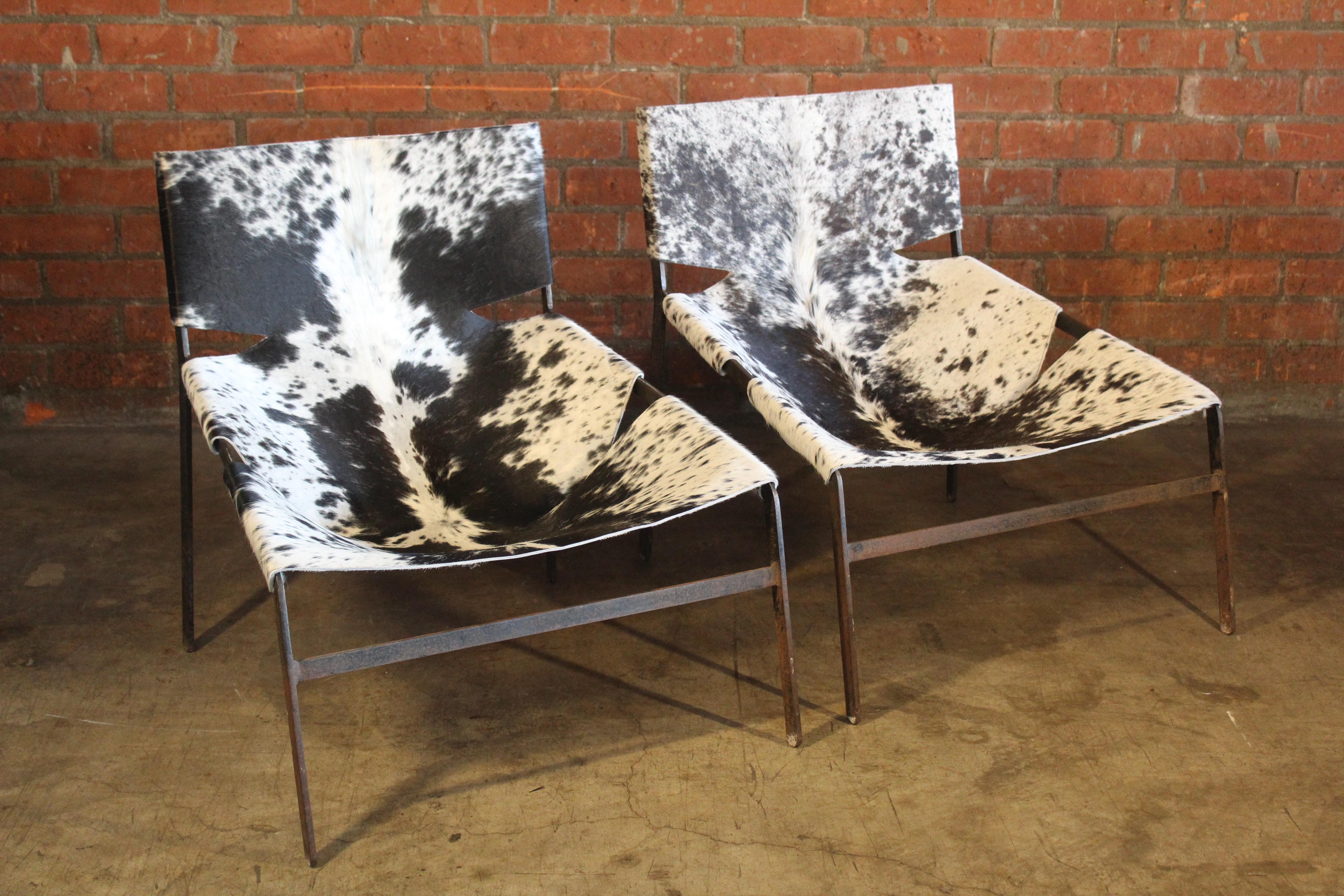 Pair of iron lounge chairs with new cowhide slings. The iron frames show patina. Unknown designer, attributed to Pierre Paulin. Most likely from Netherlands, 1960s.
