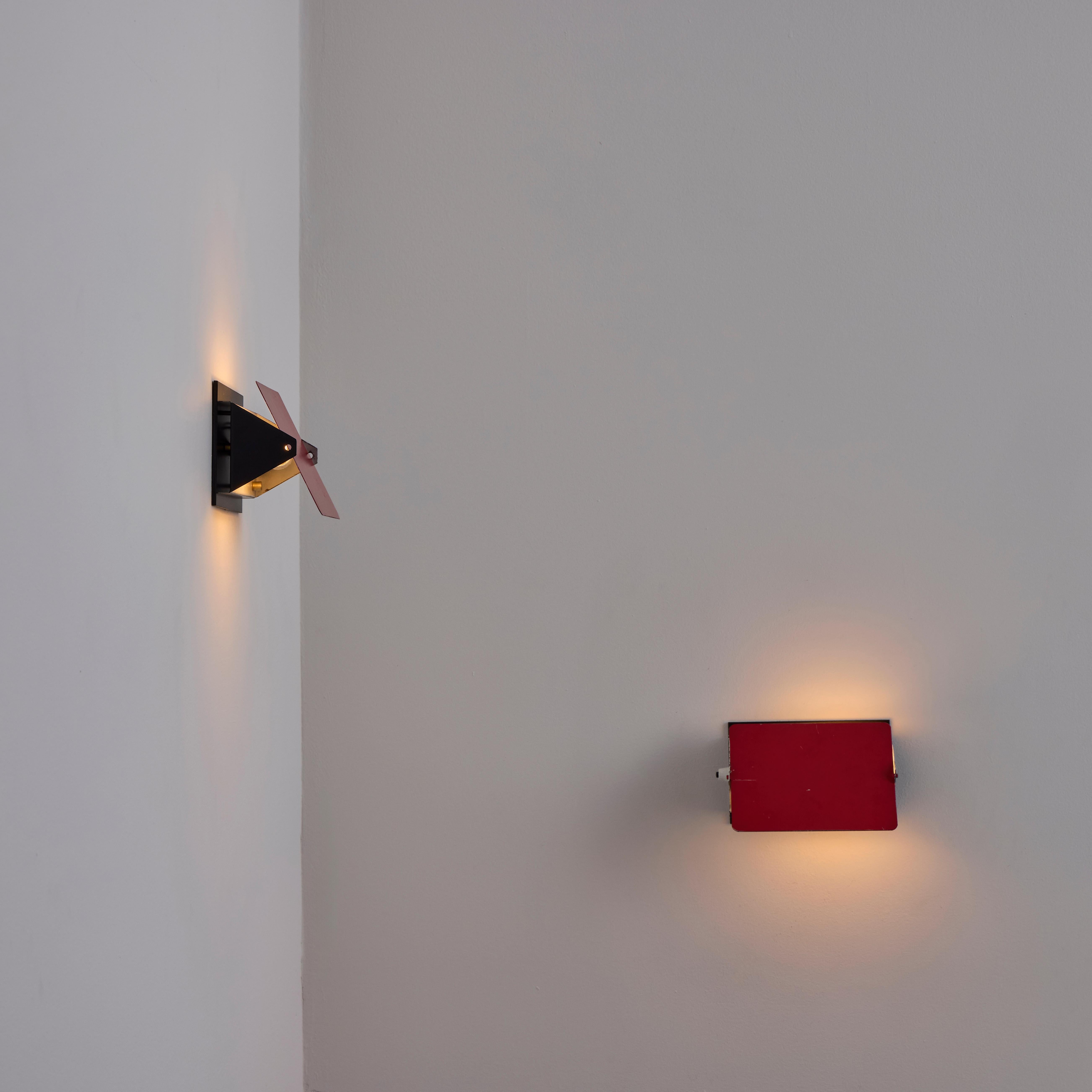 CP1 sconces by Charlotte Perriand. Designed and manufactured in France, circa the 1960s. Red and black enamel. Red panel can pivot to flap forward in either direction vertically. Mounting for horizontal application only. We recommend one 2540w