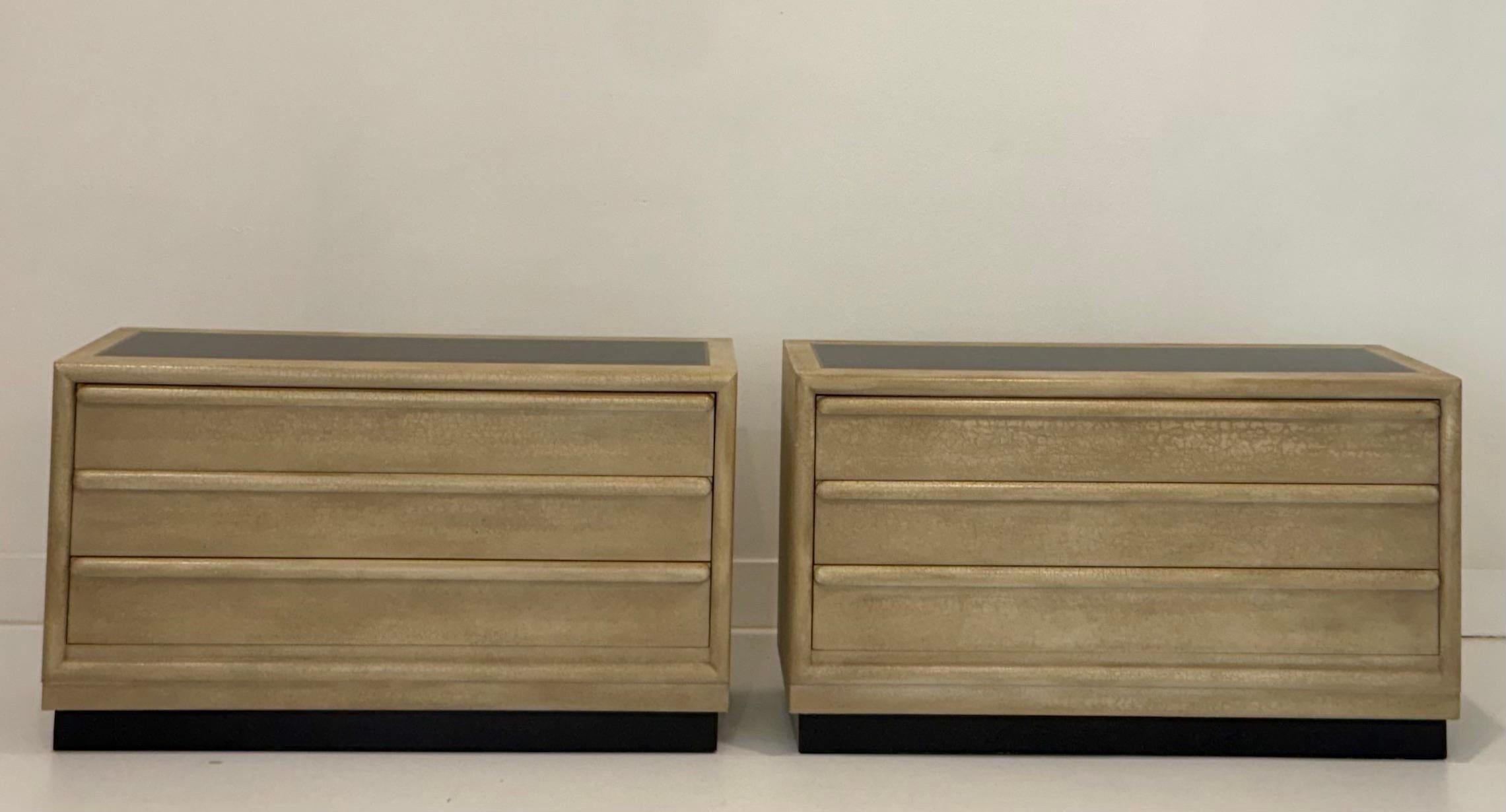 This pair of crackle finish three-drawer chests by Grandwood Furniture offers a distinctive blend of west coast craftsmanship and textural sophistication. Each chest features a sculptural silhouette with rounded drawer fronts and a deeply tactile