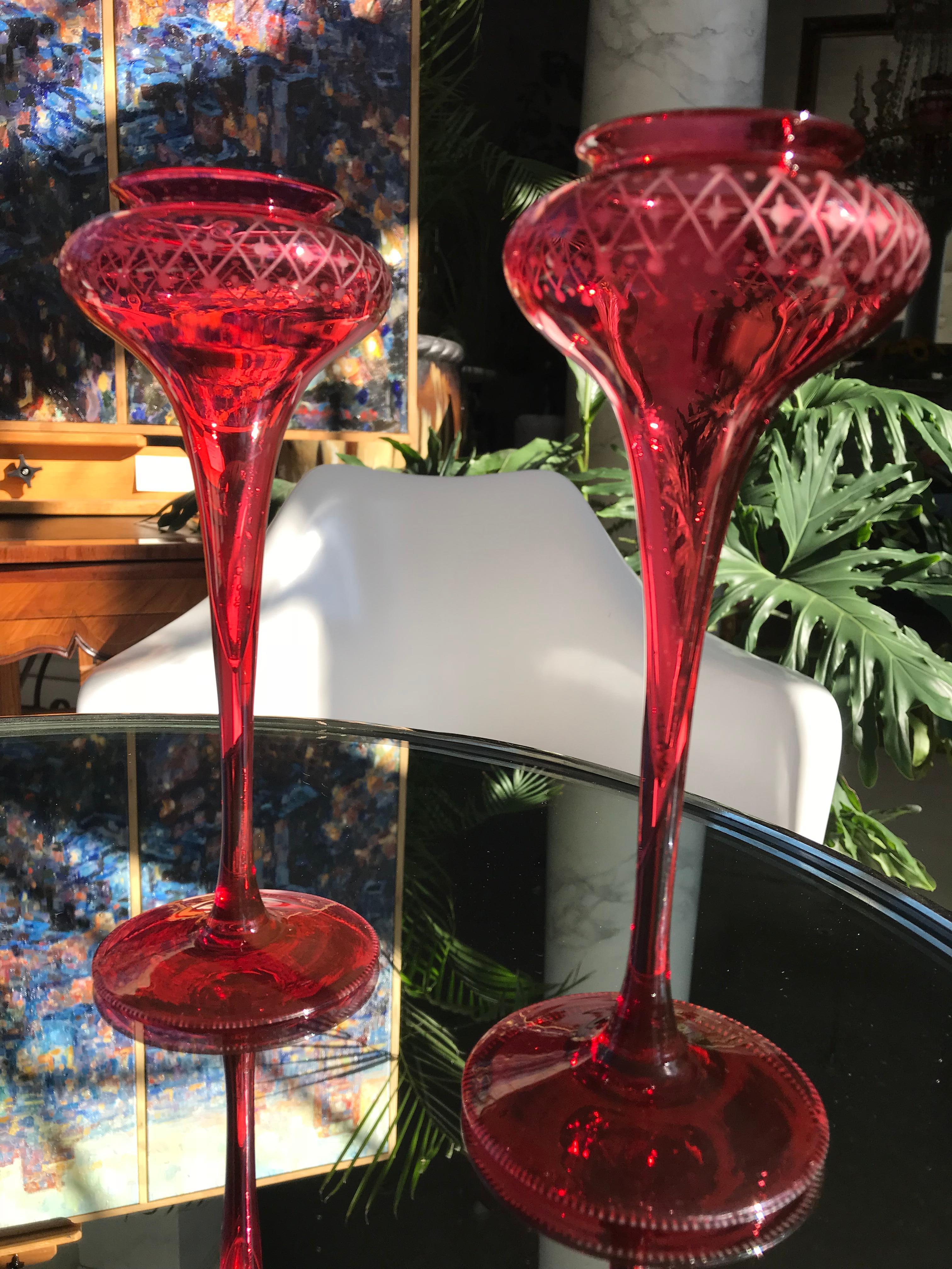 Cranberry glass is the rarest color to come by and even more unique are trumpet vases like these. They are handblown in the early 20th century in England and have delicate diamond patterns etched below the rim and the outer edge of the base.