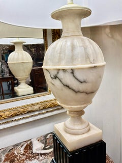 Pair of cream alabaster and black wood base lamps
