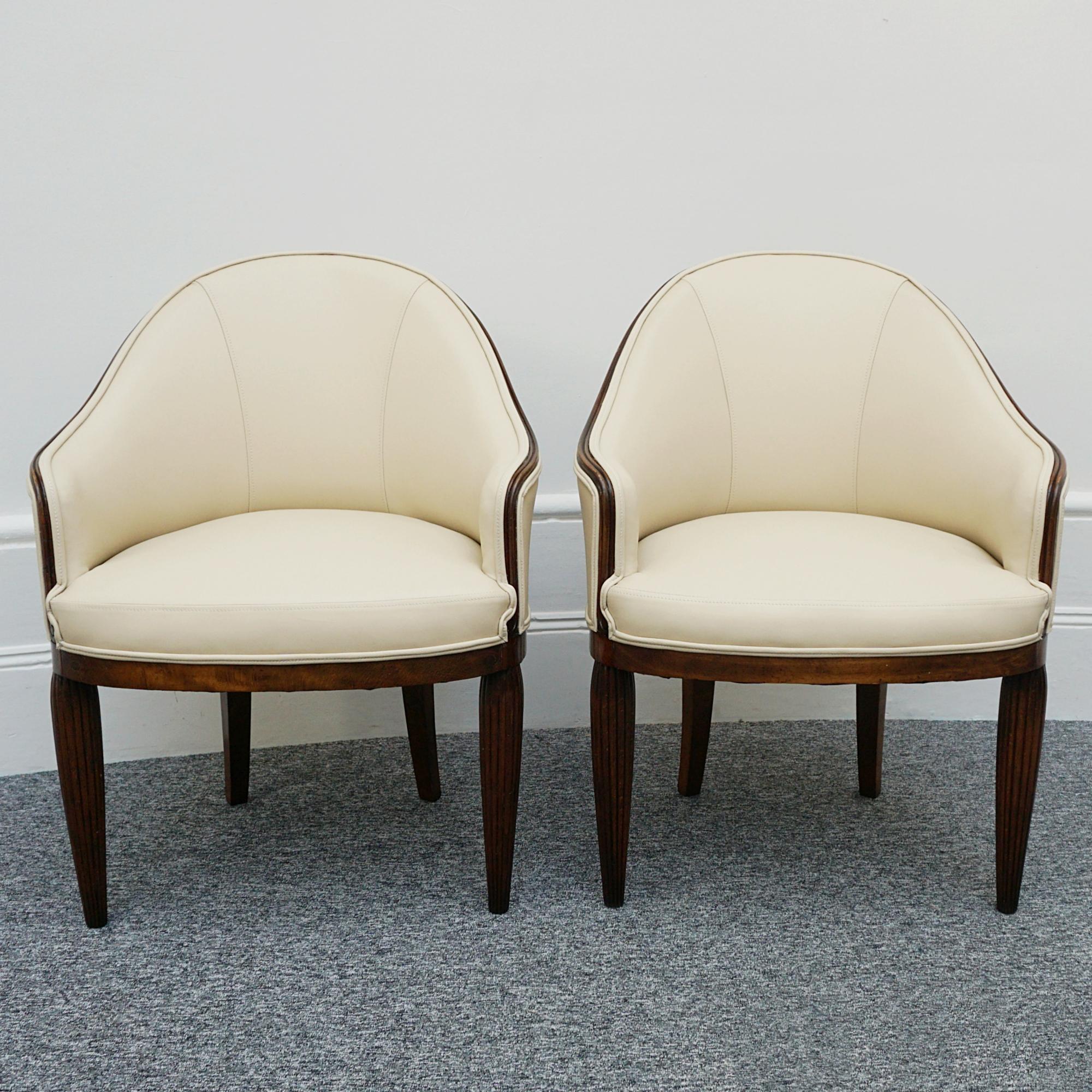 A pair of Art Deco tub chairs.  Re-upholstered in cream leather. 

All of our furniture is extensively polished and restored where necessary to the highest standards.

