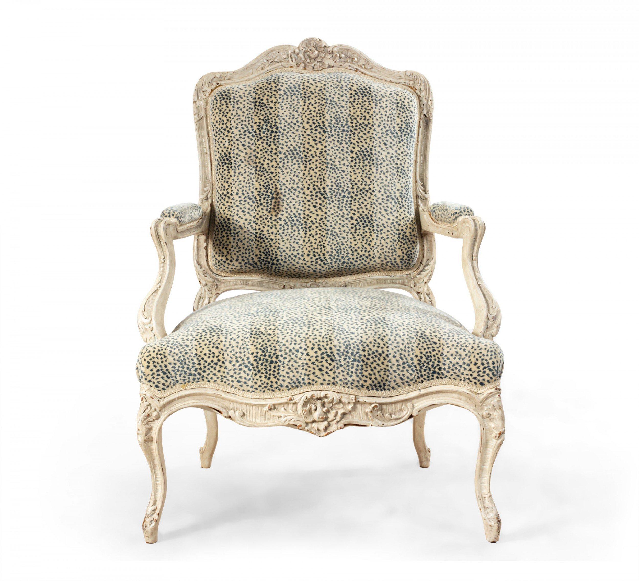 Pair of French Louis XV style white painted and carved oversized armchairs with blue and gray spotted and striped upholstery.