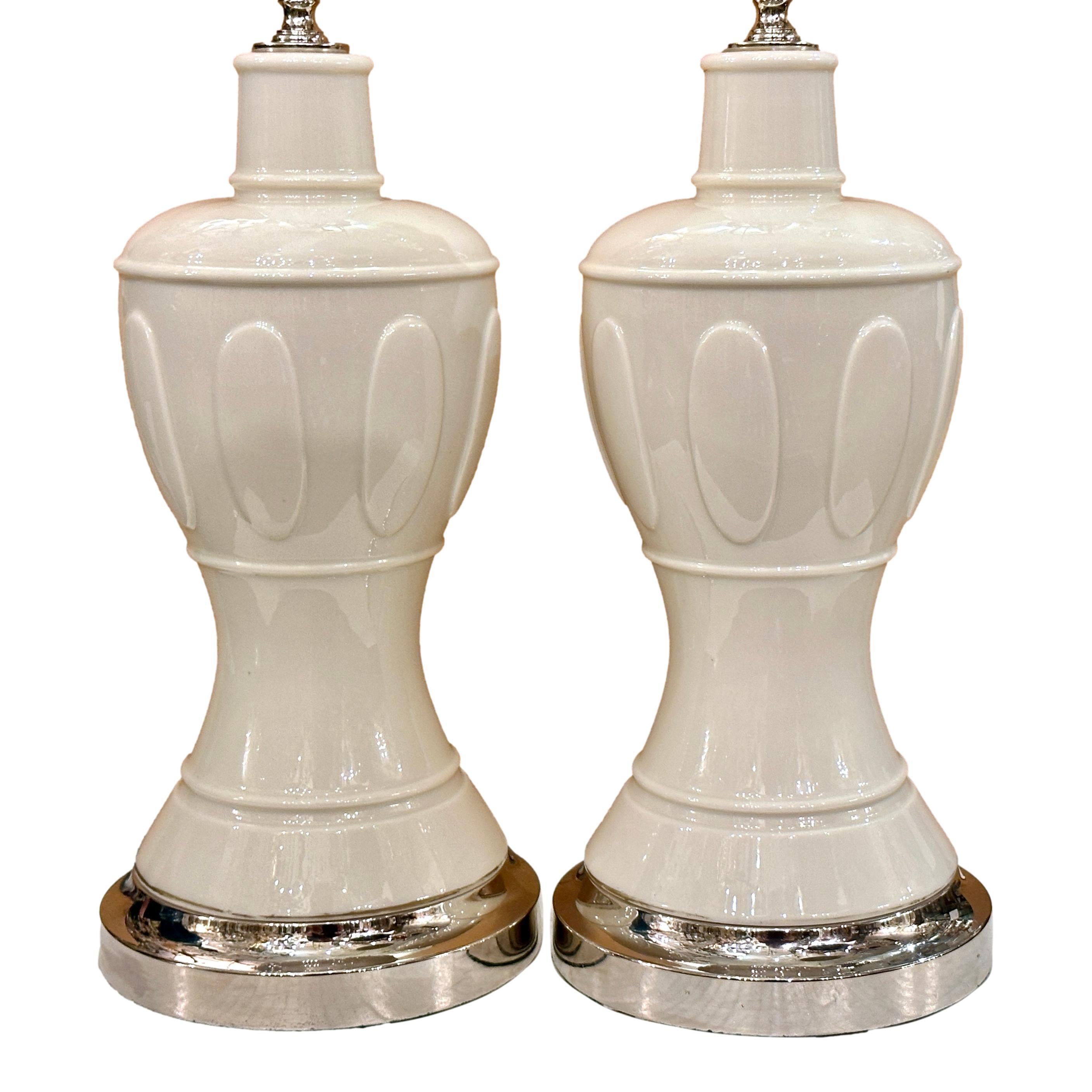 Pair of circa 1950's French porcelain table lamps with silver bases.

Measurements:
Height of body: 16