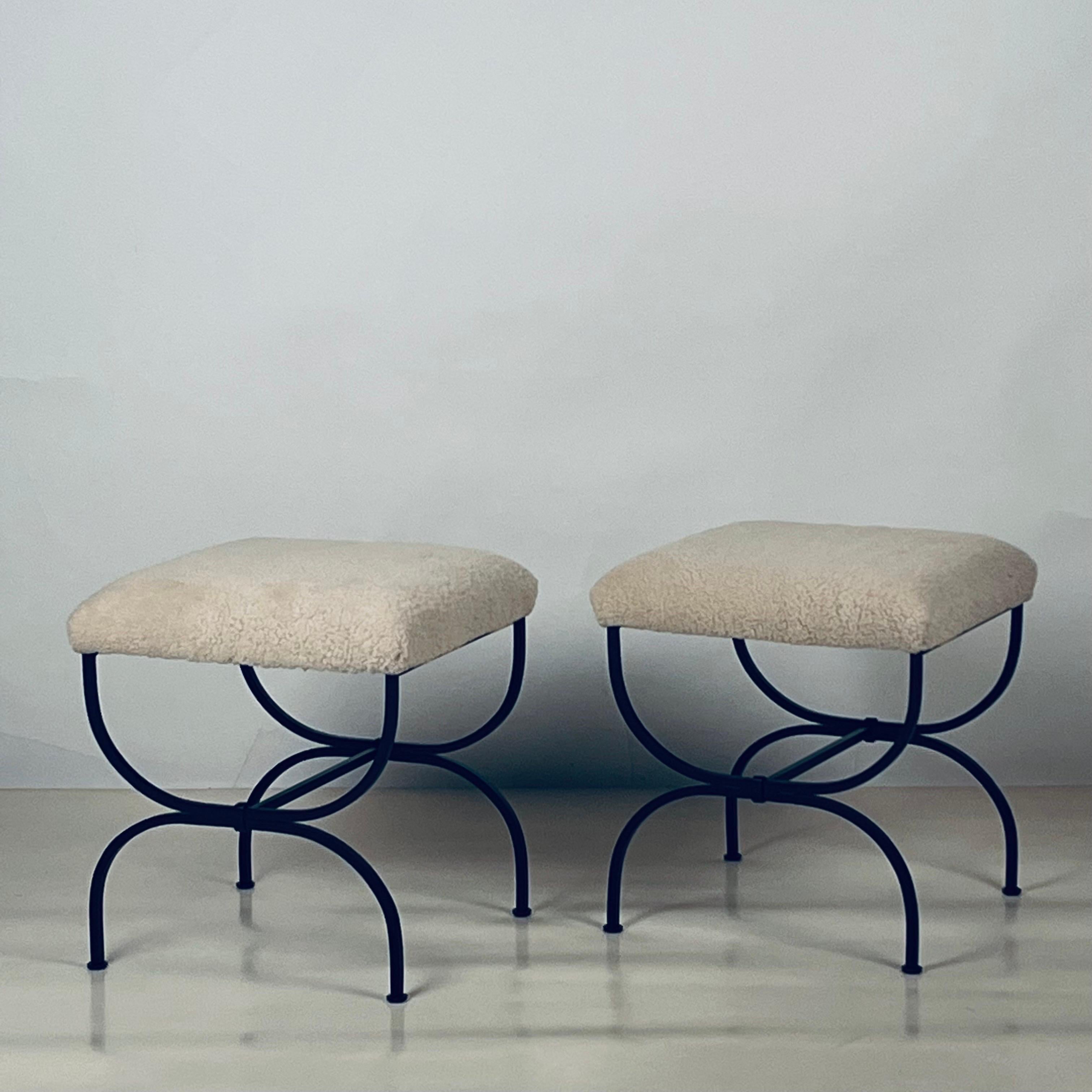 Pair of cream shearling 'Strapontin' stools by Design Frères.

Chic and understated.

Also great as a two-part bench.