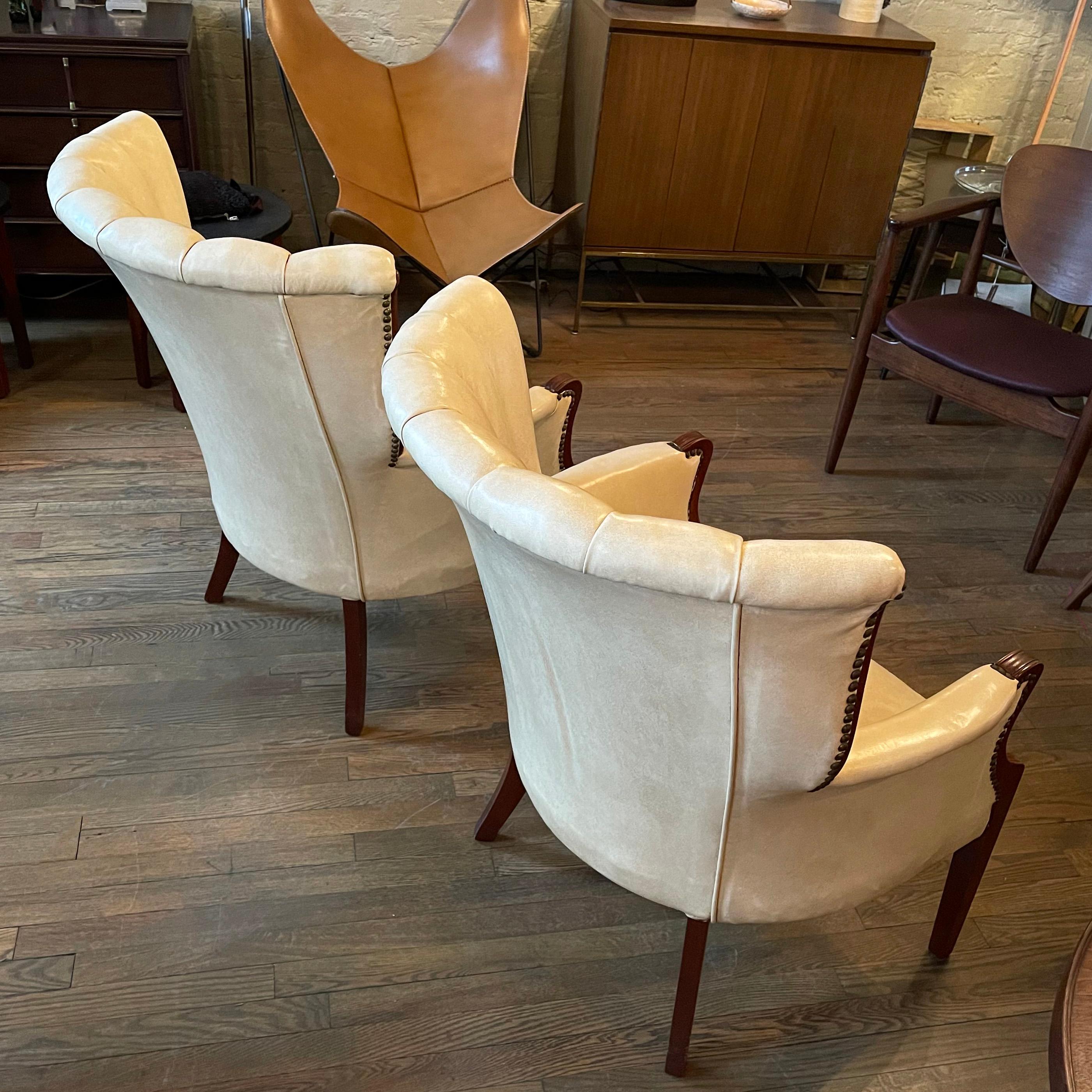 Faux Leather Pair of Cream Vinyl Mahogany Wingback Armchairs