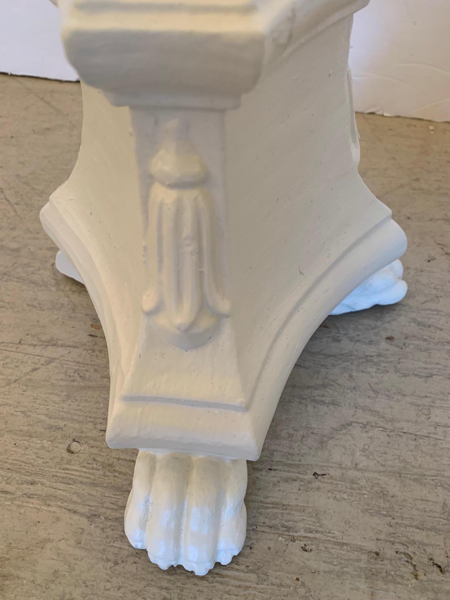 Cream painted carved wood candle holders having paw feet and tassel like decoration.
Tops are 5