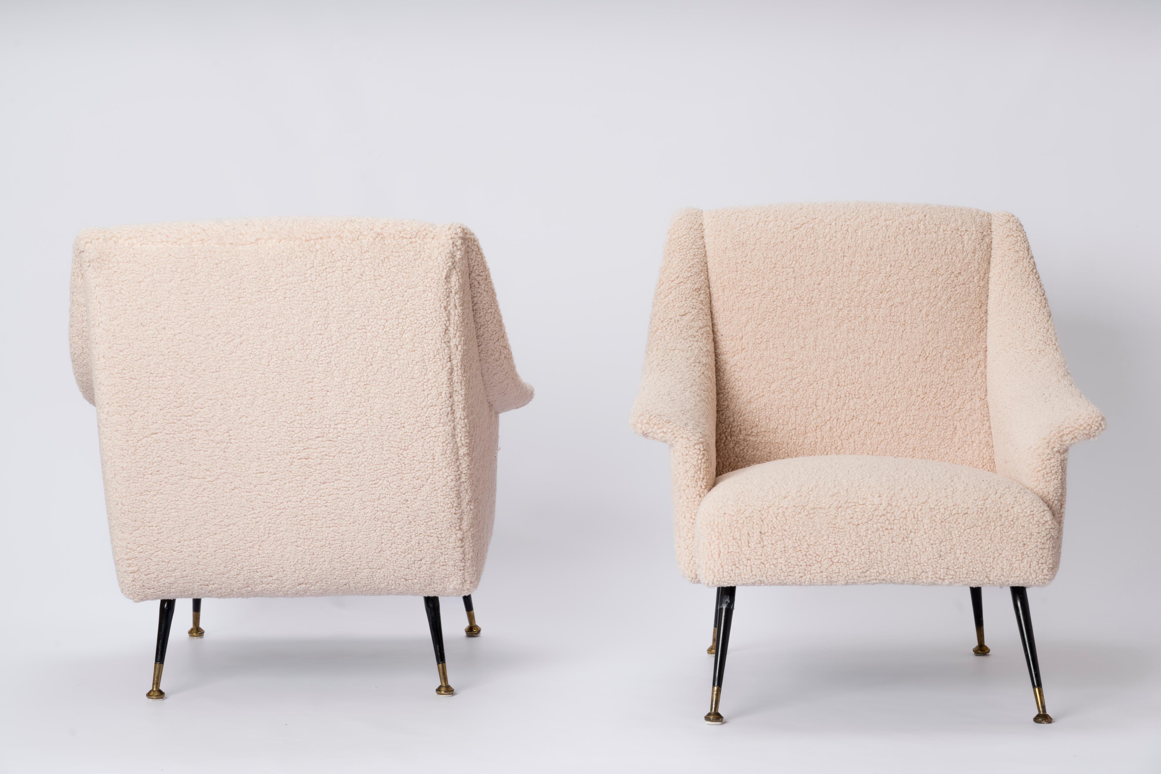 Elegant pair of Italian midcentury armchairs freshly re-upholstered in creme bouclé fabric. Their 