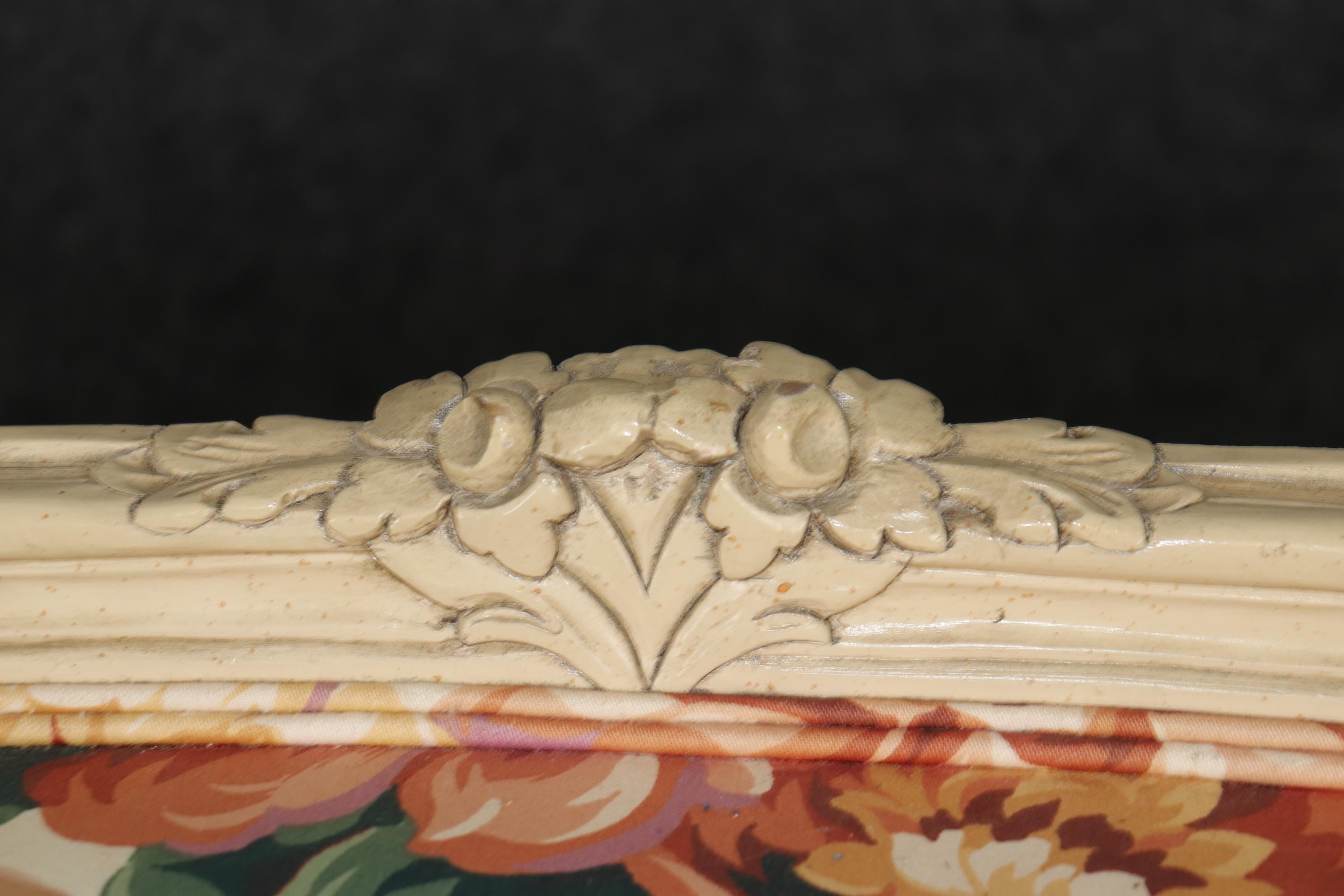 This is a gorgeous pair of floral upholstered paint decorated settees. The settes are in good used vintage condition and feature lively upholstery that are perfect for a sun room, or a Florida condo. The sofas are from the 1950-60s era and may have