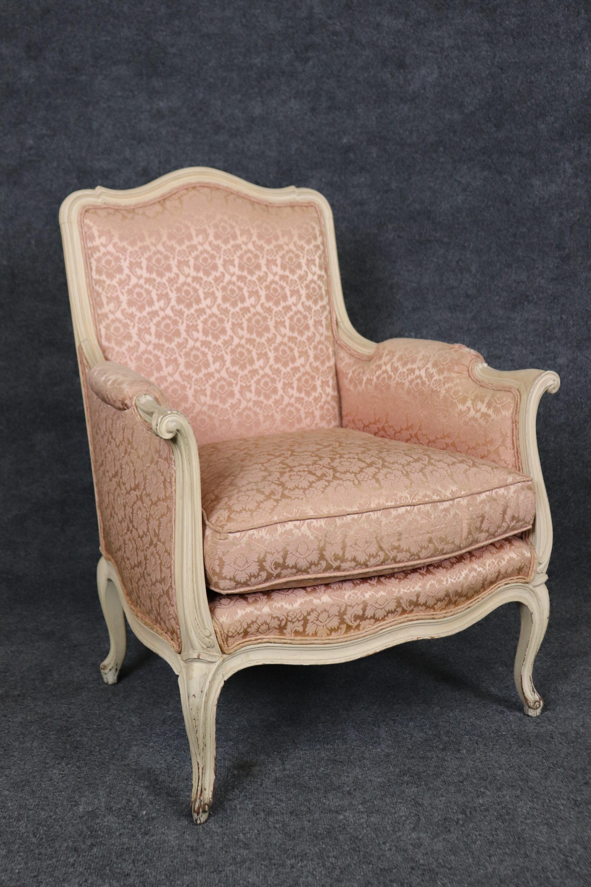 These painted distressed creme and rose blush bergeres are in good vintage condition and will show signs of age and wear from years of use., They are shown with paint losses and good upholstery but as the upholstery is original they will have