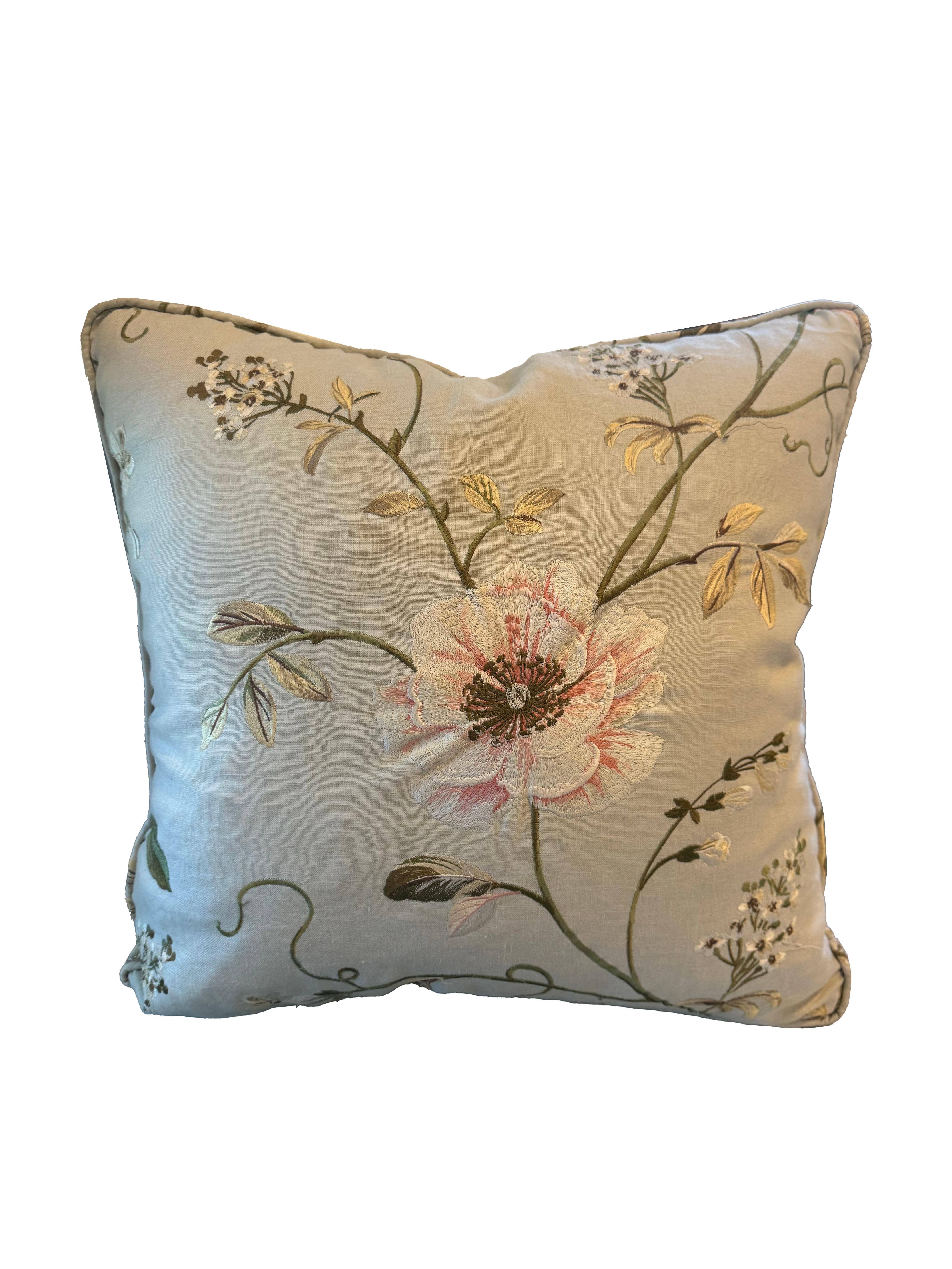 Enhance your living space with this exquisite pair of crewelwork pillows. The beautiful embroidery, featuring a captivating floral motif, is showcased on a soft, pale bluish-gray linen background, creating a harmonious blend of elegance and