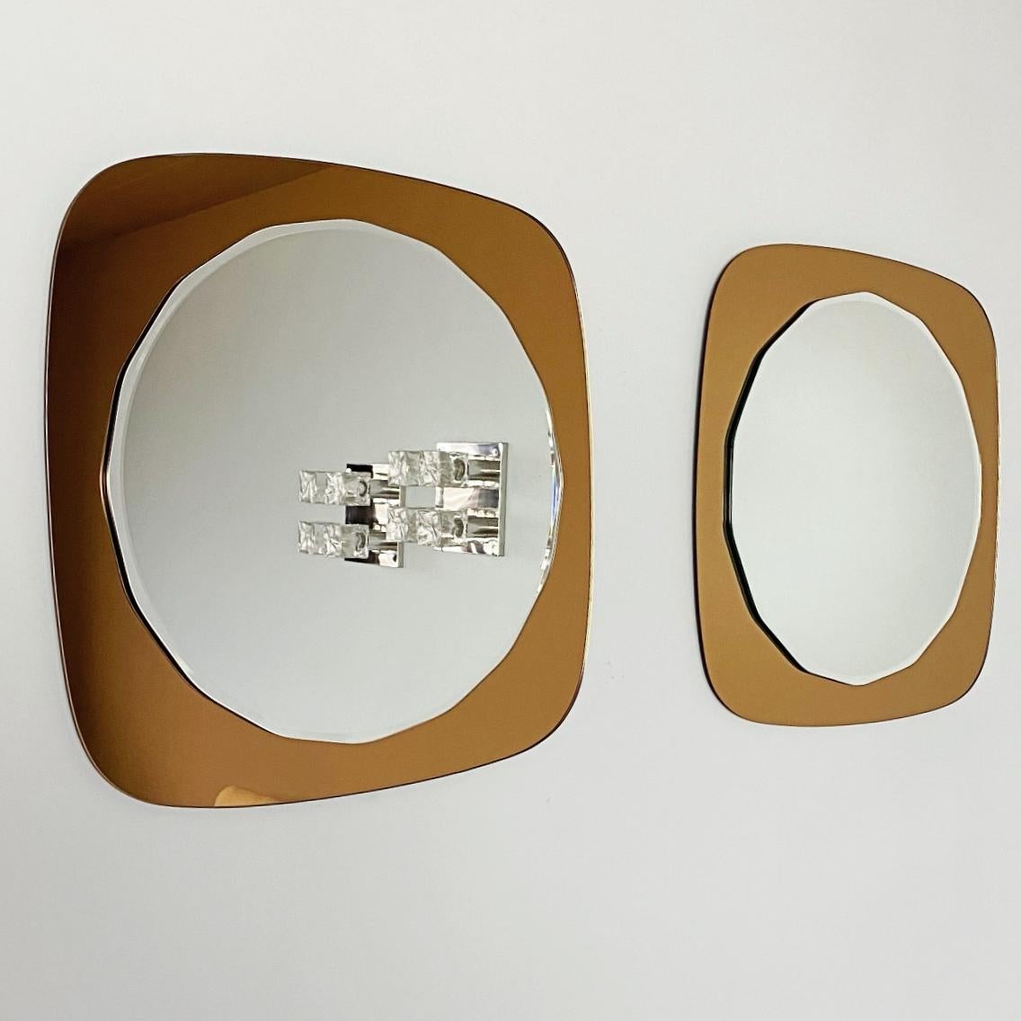 Pair of Crystal Art beautiful faceted mirrors on rose gold crystal glass mirror frame, made in 1970s, Italy. We love to create the illusion of space and decorate any room in contemporary style with such a modern frameless wall mirror.
The mirrors