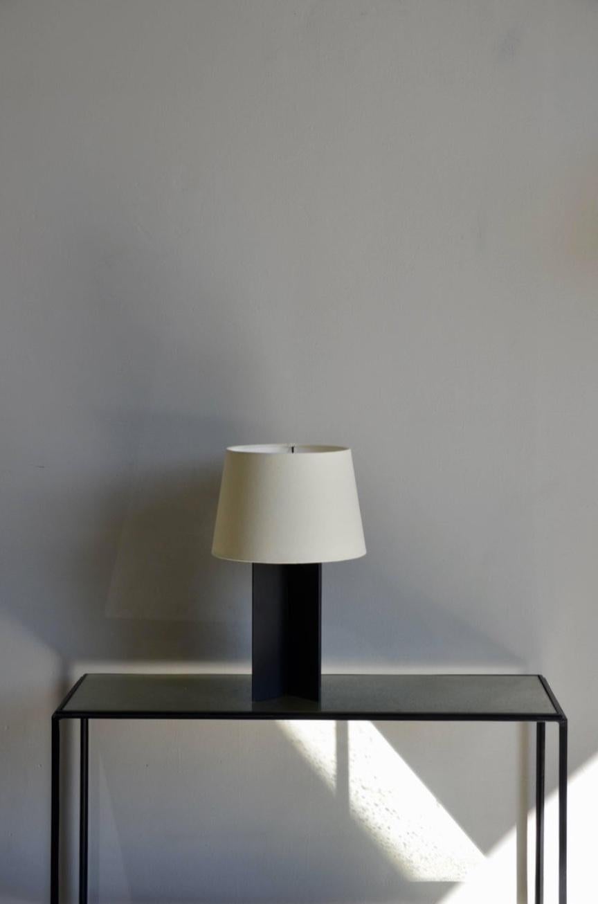 Chic pair of 'Croisillon' matte black steel and parchment lamps by Design Frères. European style shade with bottom ring (no finial).

These lamps by Design Frères are curated for you.