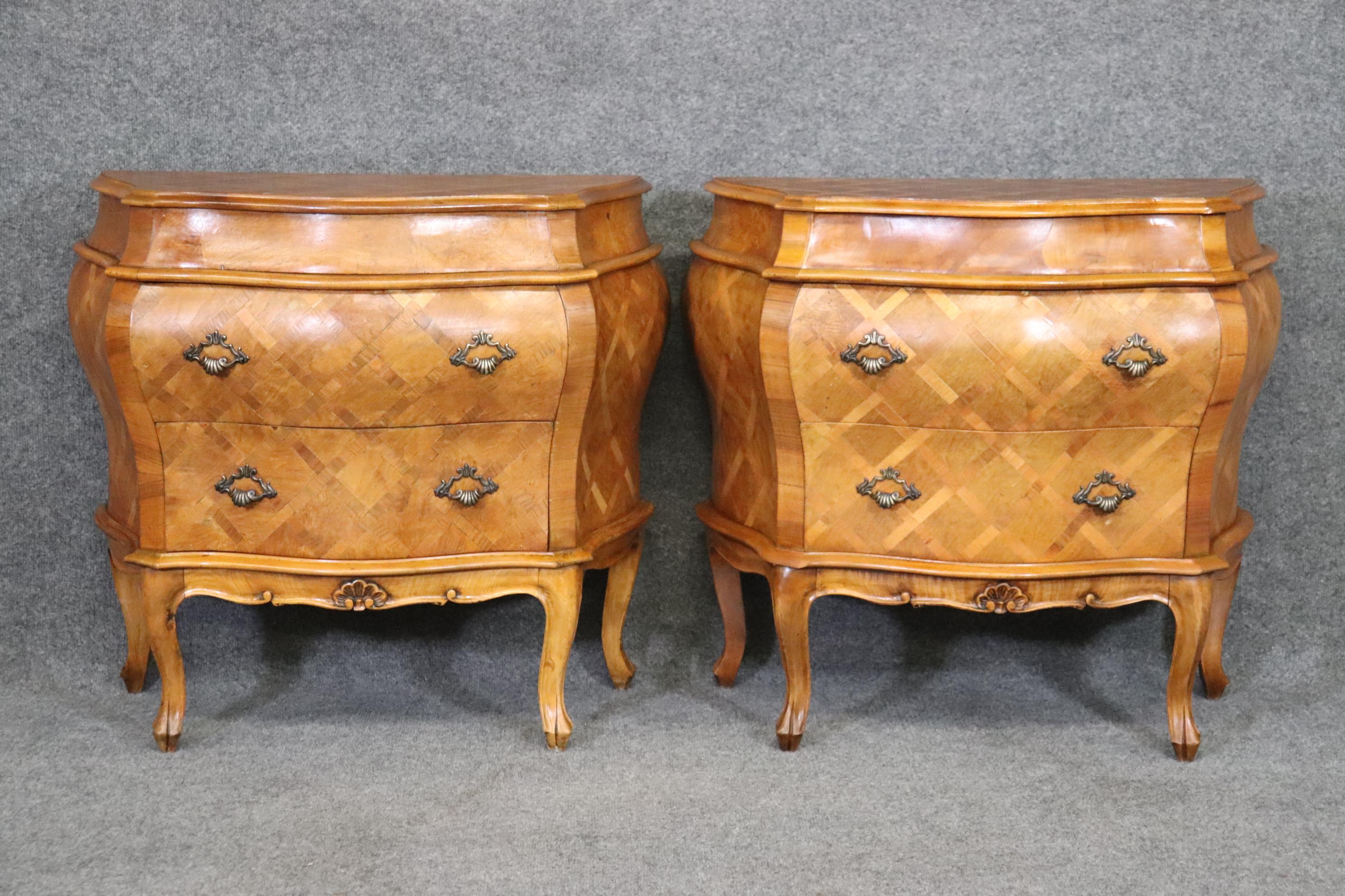 This is a beautiful pair of cross-hatch inlaid olivewood commodes or nightstands with finished backs. They are in good vintage condition and one is slightly darker than the other due to to sunlight fading. The stands are have brass handles and in