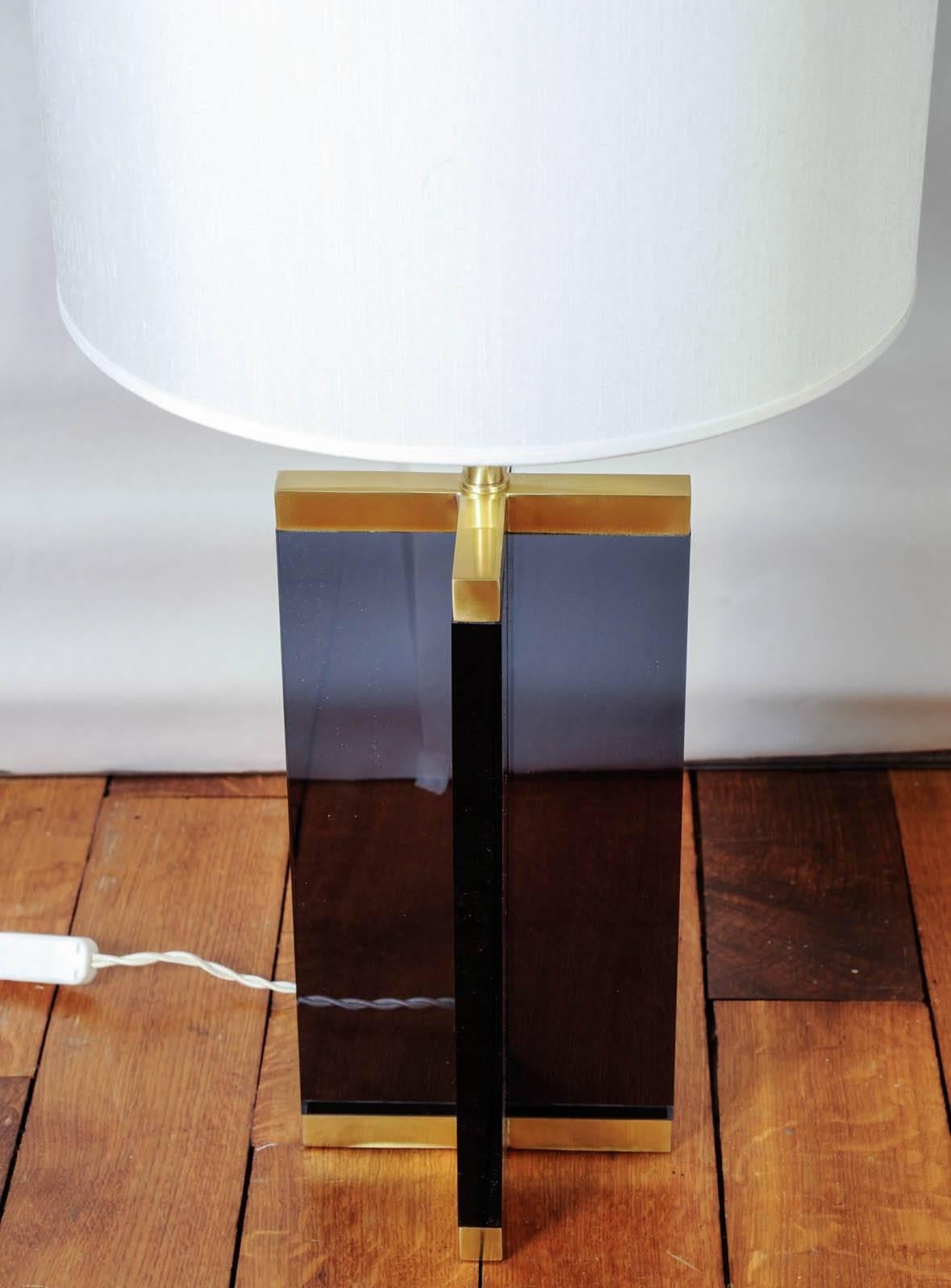 Pair of table lamps made of tall cross of dark plexiglass set with satin brass.