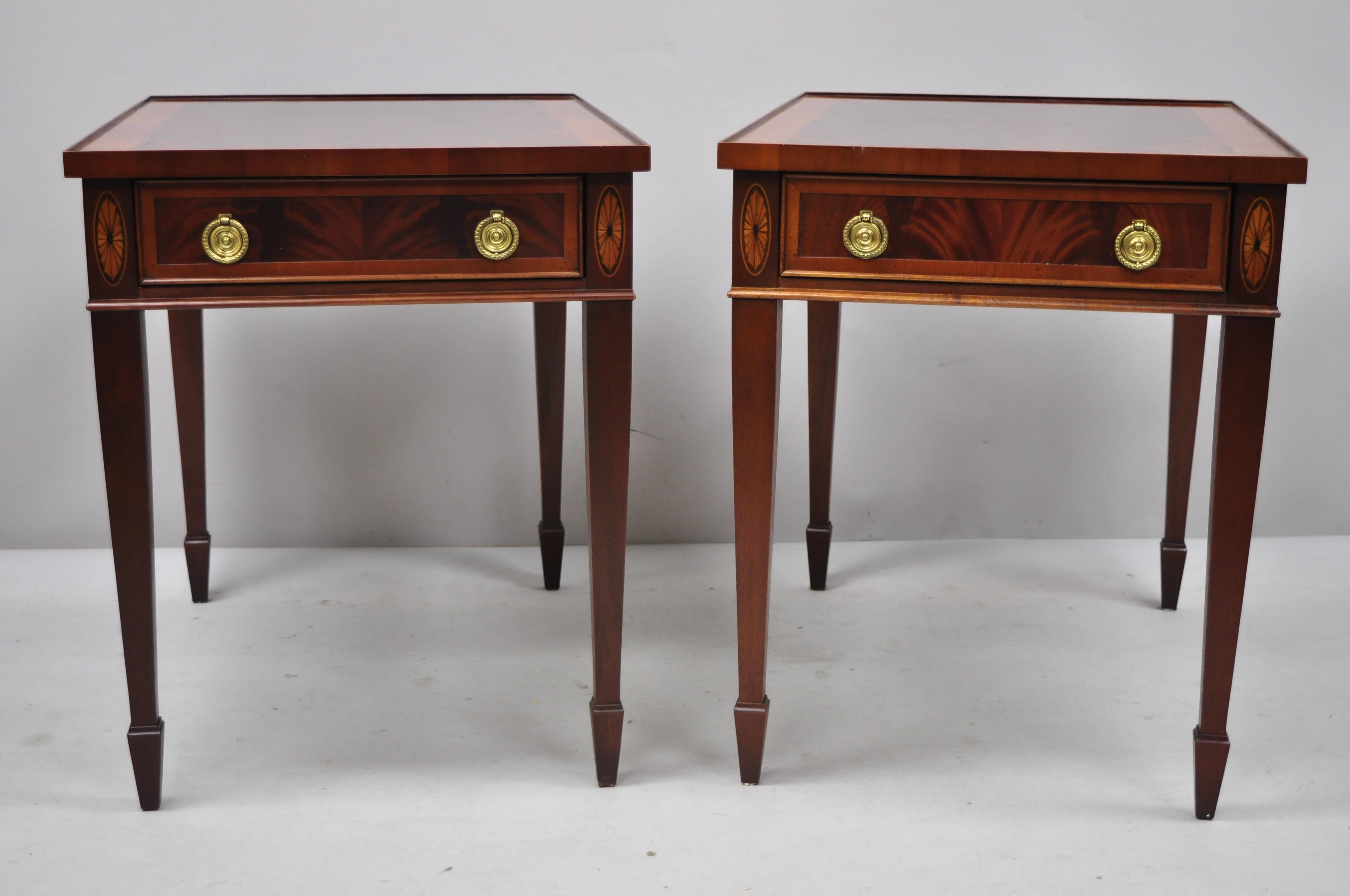 Pair of crotch flame mahogany Sheraton Federal style Hekman end tables. Listing includes beautiful wood grain, finished back, original label, 1 dovetailed drawer, tapered legs, nice inlay, quality American craftsmanship, circa mid-late 20th century.