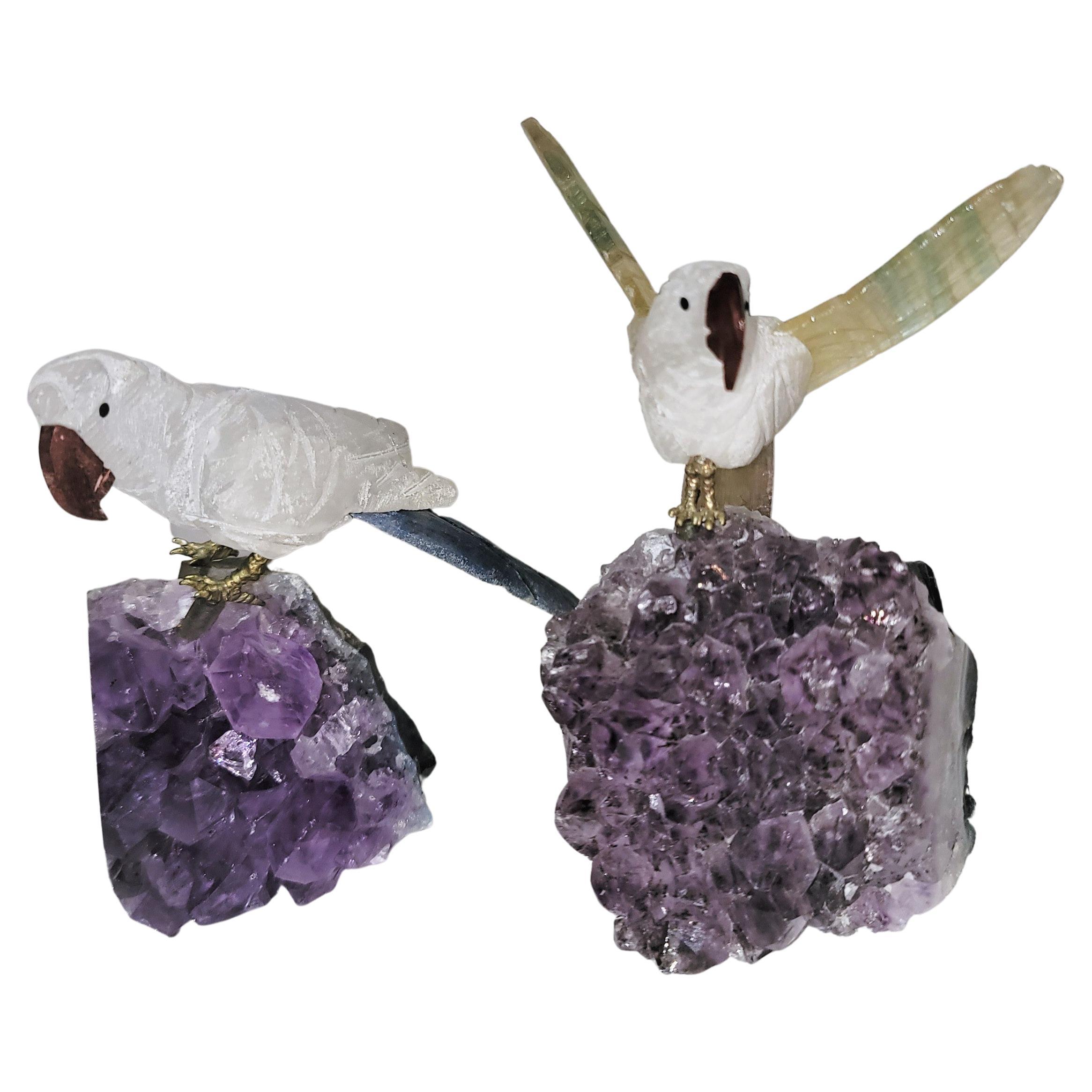 Pair of crystal and amethyst birds. Great color and very attractive. The birds are removable and have small holes where stands are placed to be held within the amethyst rock.

Bird with open wing span measures - 
3.5 W x 4.25 H x 3.25 D

Bird with